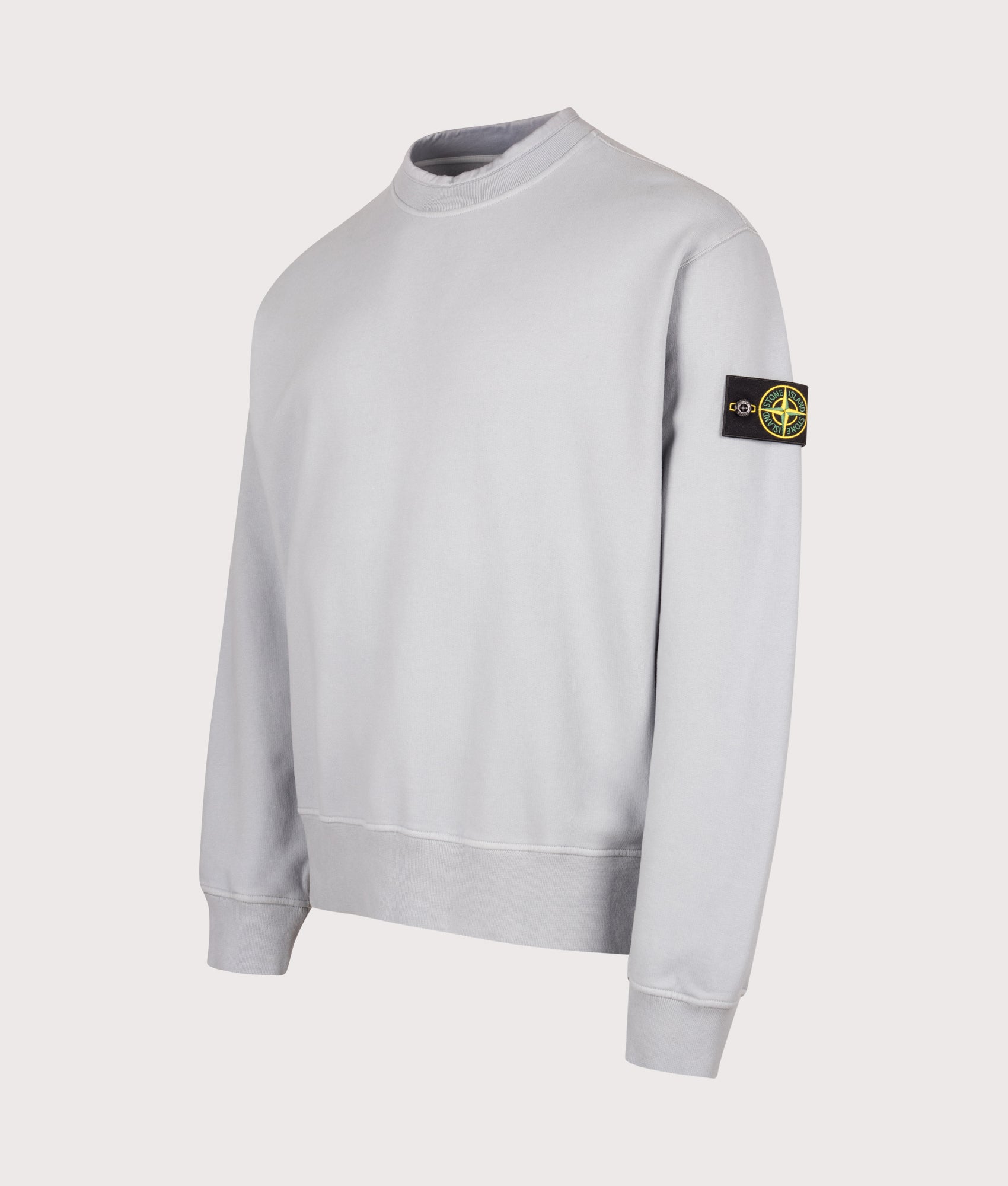 Stone Island Oversized Fit Brushed Organic Cotton Fleece Sweatshirt in Ash Grey at EQVVS Menswear. Angled front shot.