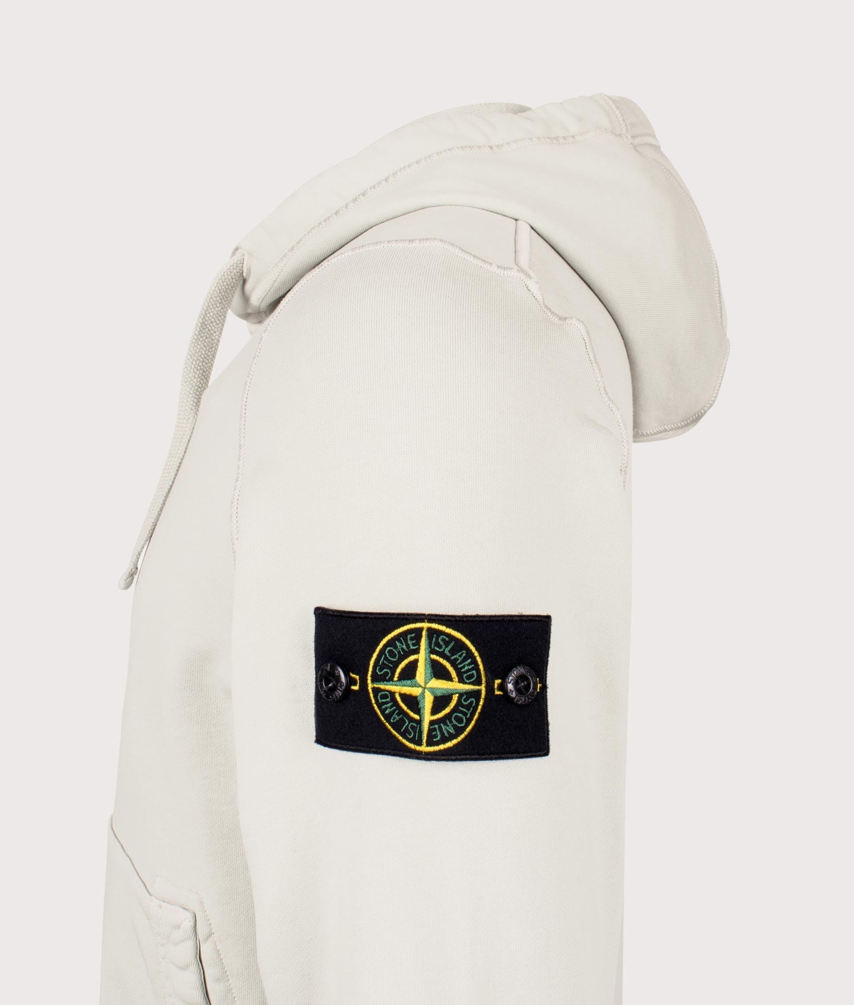 Stone Island Organic Cotton Hoodie in Pearl Grey at EQVVS Menswear. Side detail shot.