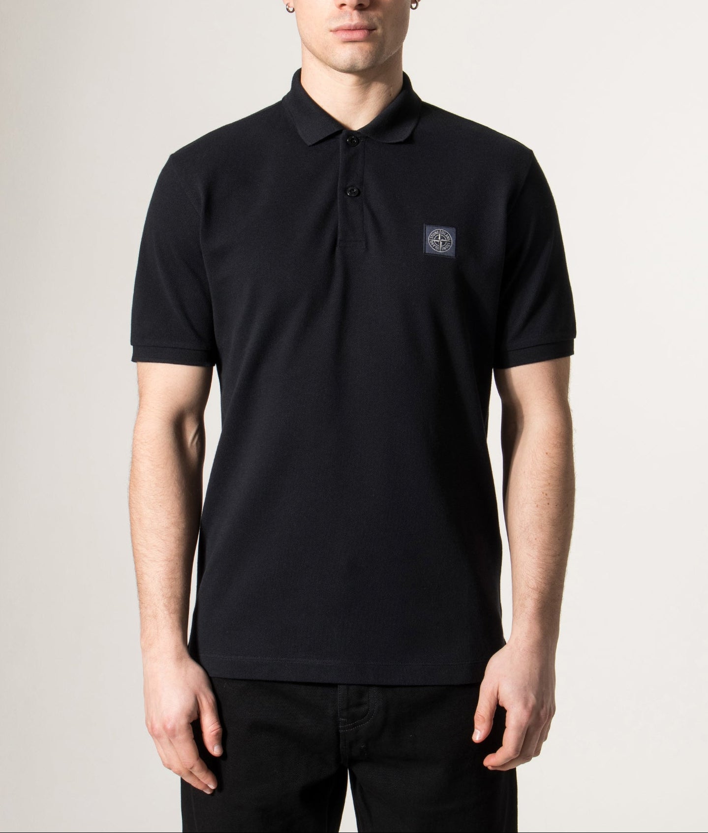 Stone Island Compass Patch Polo Shirt in Navy Blue at EQVVS Menswear. Model front shot.