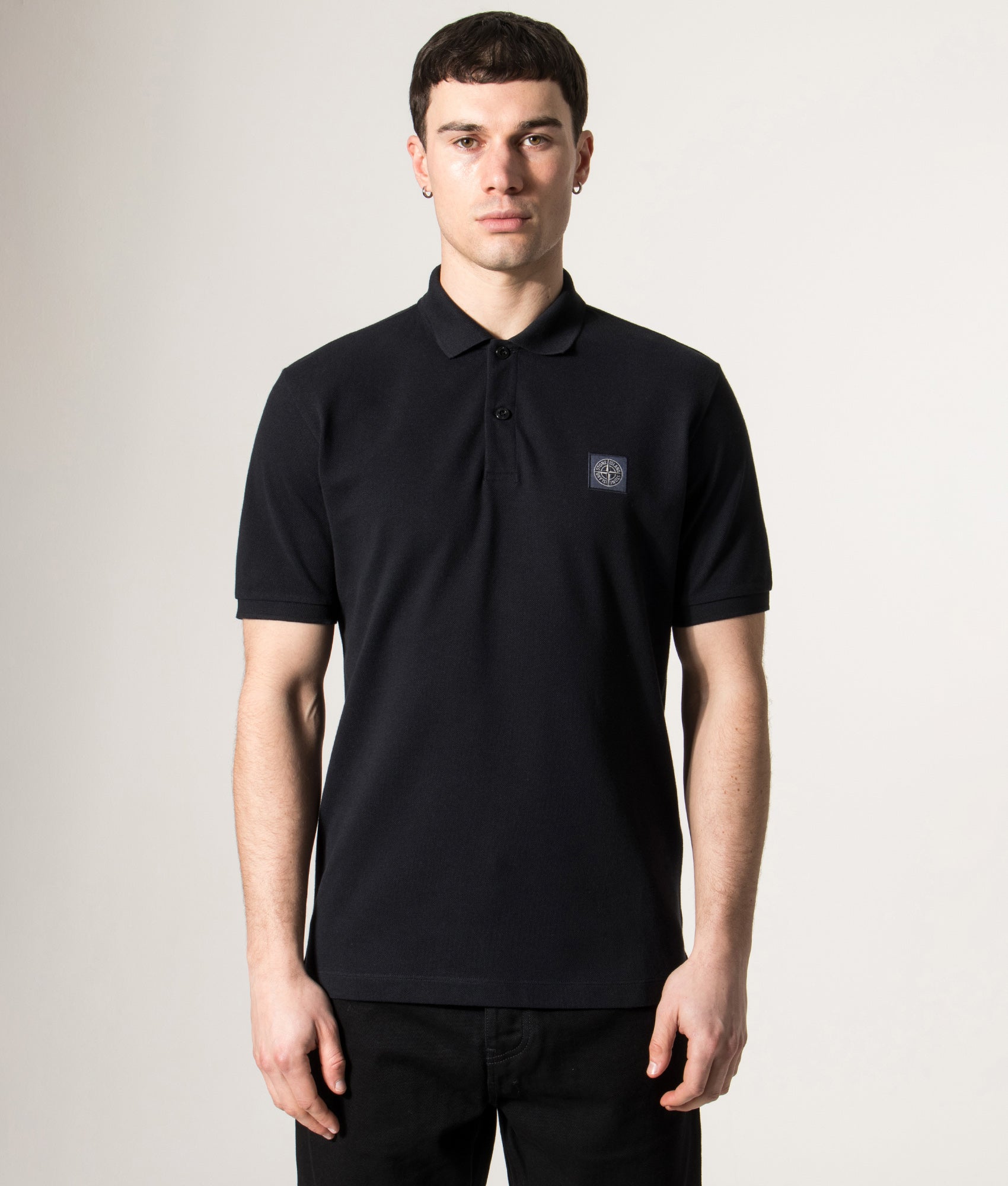 Stone Island Compass Patch Polo Shirt in Navy Blue at EQVVS Menswear. Model front shot.