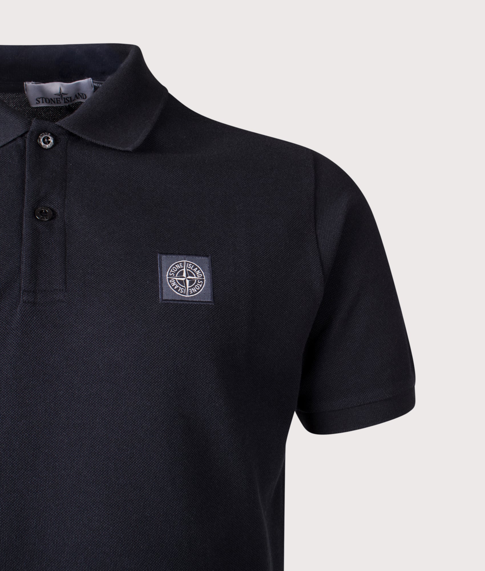 Stone Island Compass Patch Polo Shirt in Navy Blue at EQVVS Menswear. Detail shot.
