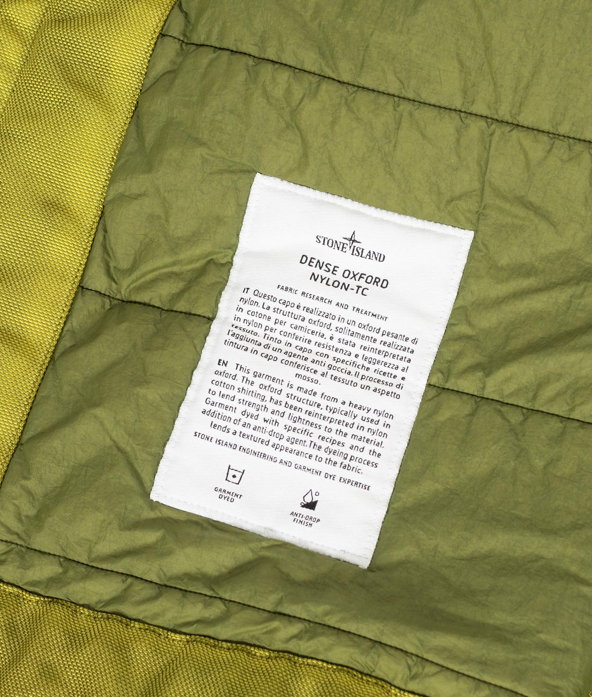 Stone Island Dense Oxford Nylon-TC Jacket in Cactus at EQVVS Menswear. Label shot.