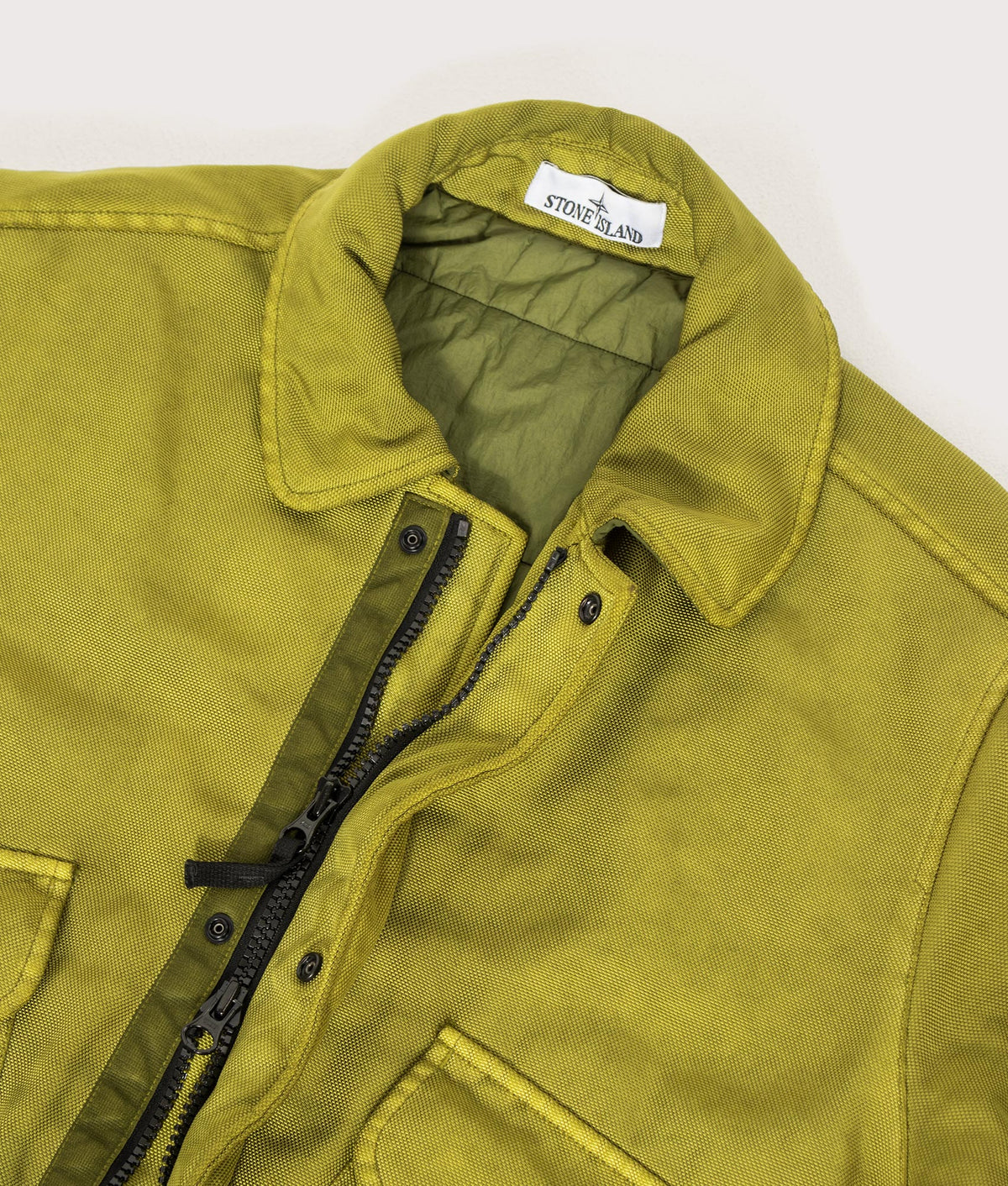 Stone Island Dense Oxford Nylon-TC Jacket in Cactus at EQVVS Menswear. Collar and zip detail shot.