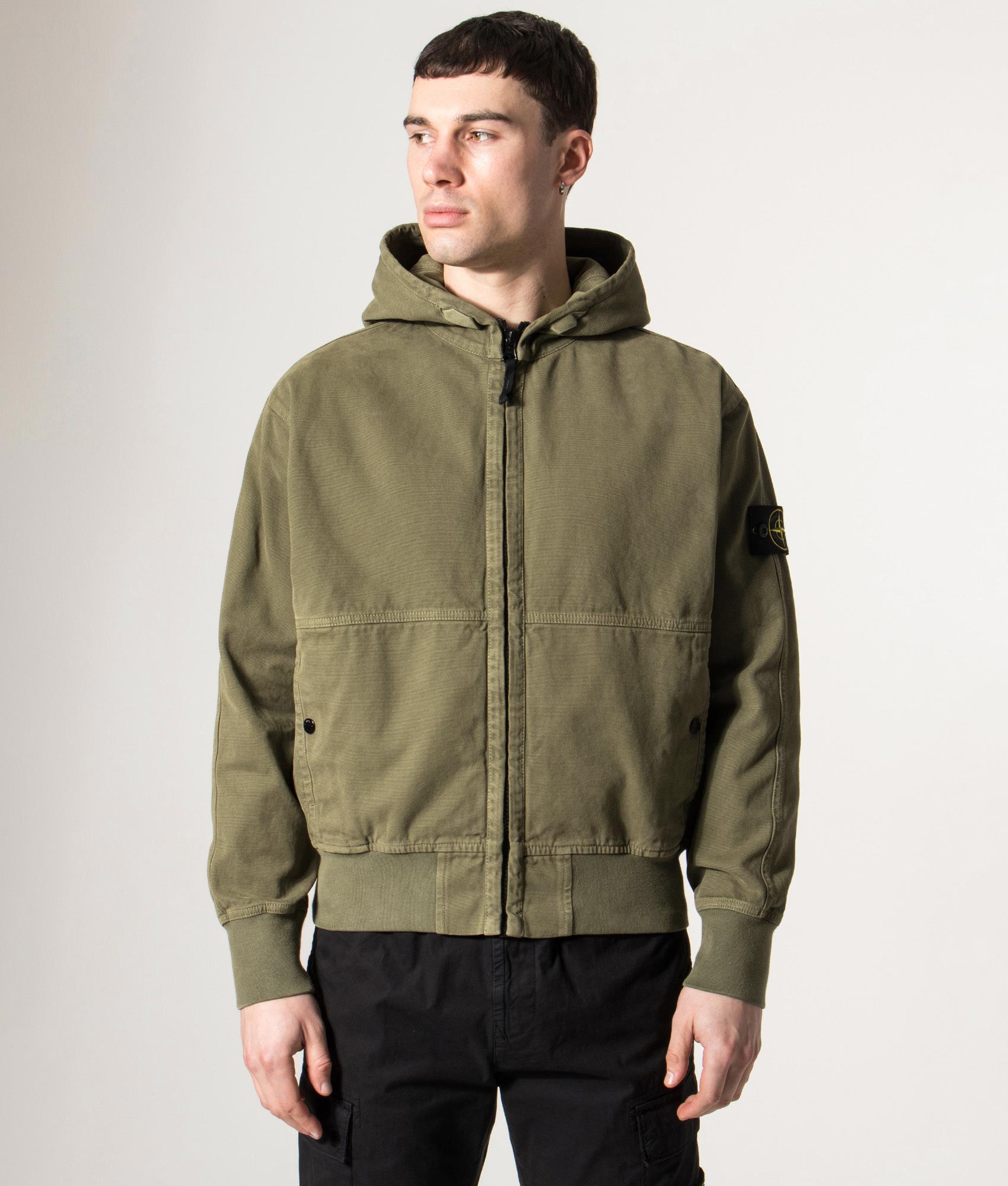 Stone Island Relaxed Fit Panama ‘Old’ Effect Zip Through Hoodie in Military Green at EQVVS Menswear. Model front shot.