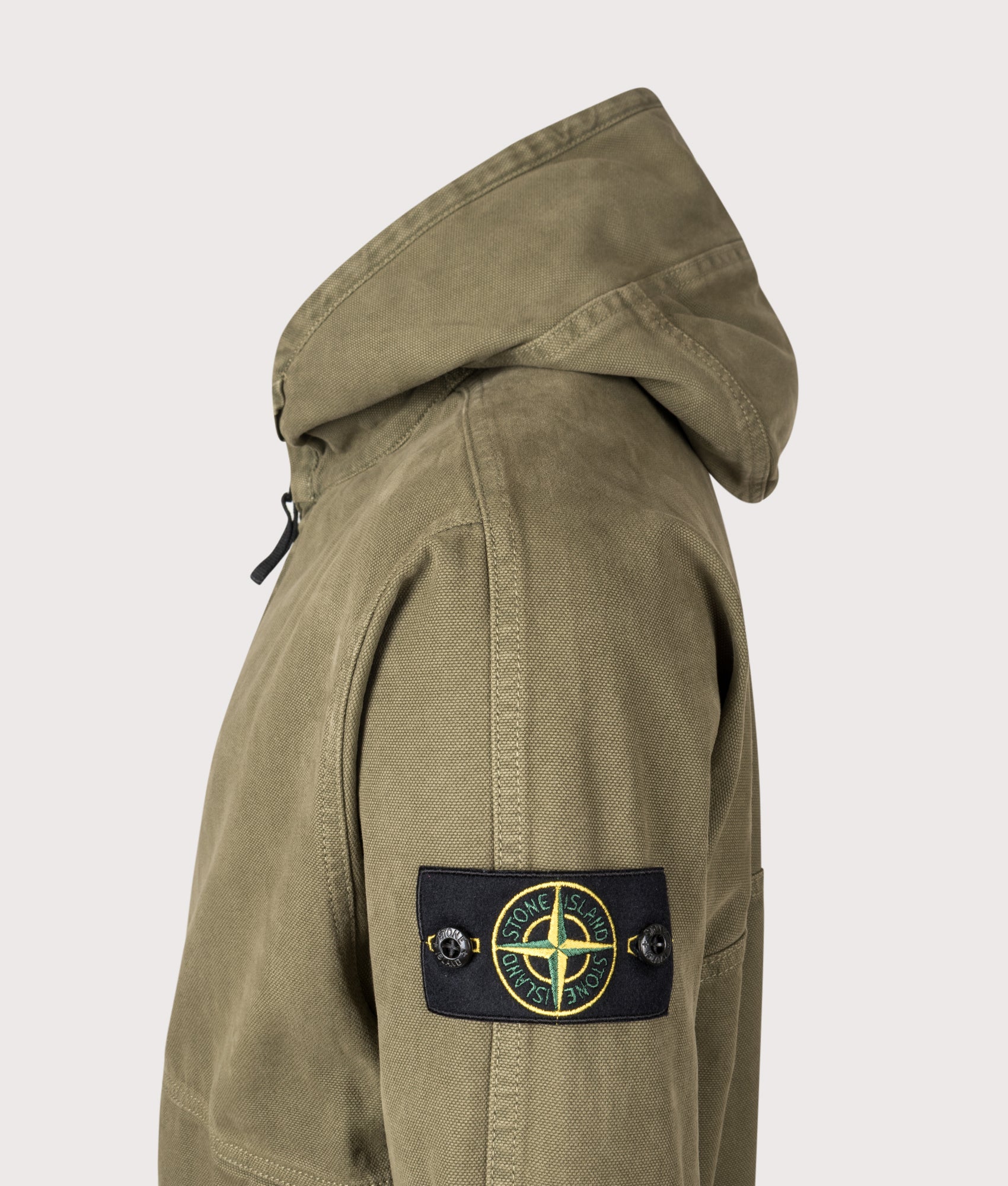Stone Island Relaxed Fit Panama ‘Old’ Effect Zip Through Hoodie in Military Green at EQVVS Menswear. Side detail shot 