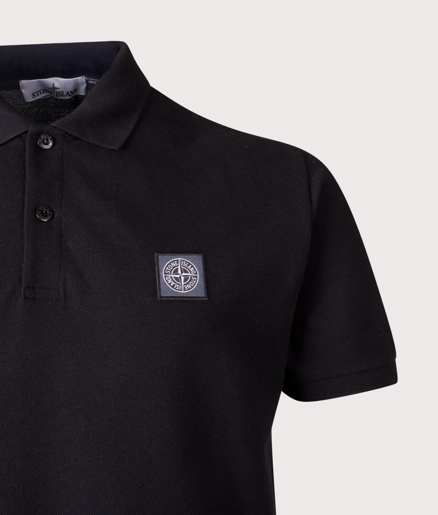 Stone Island Compass Patch Polo Shirt in Black at EQVVS Menswear. Detail shot.
