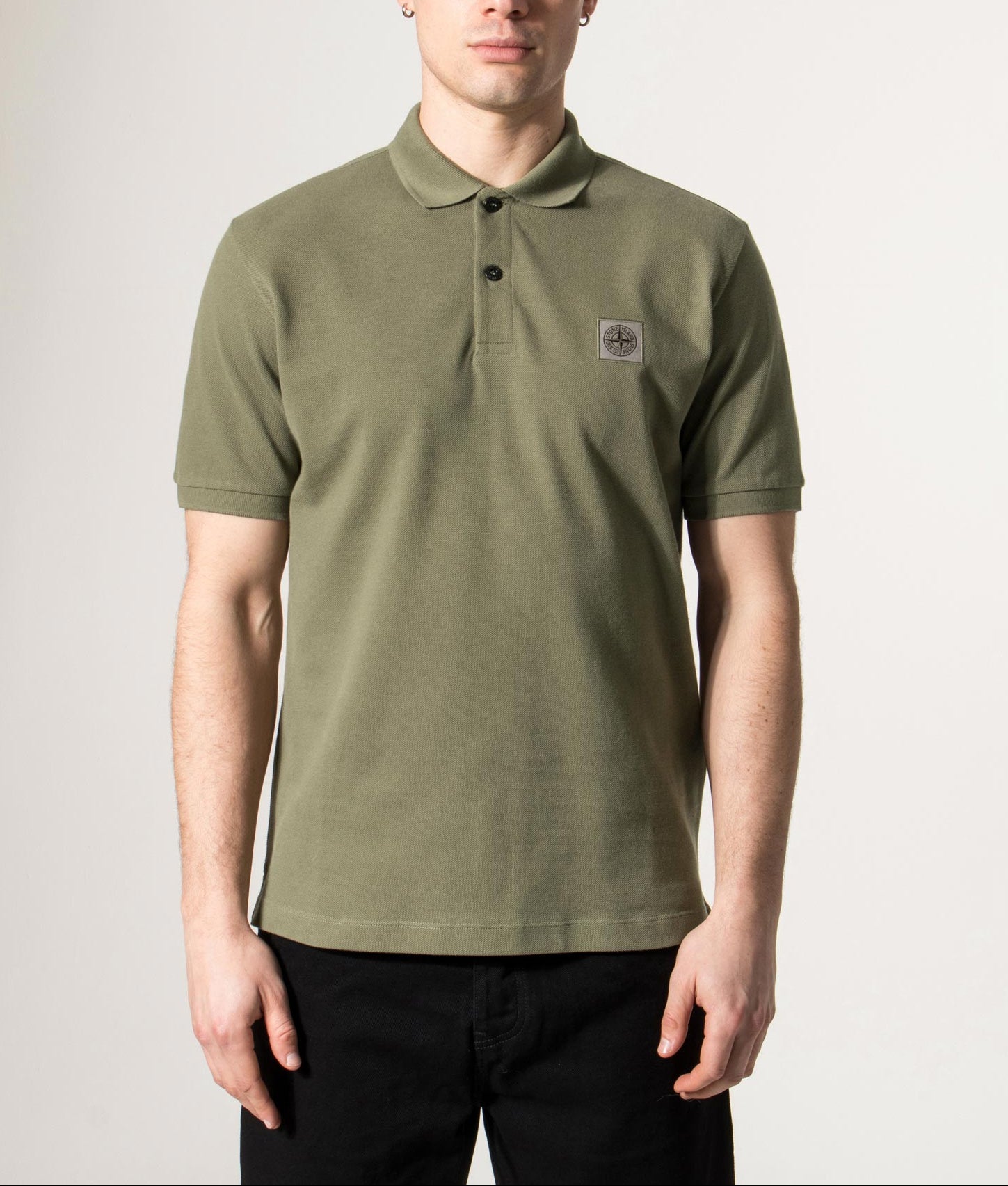 Stone Island Compass Patch Polo Shirt in Military Green at EQVVS Menswear. Model front shot.