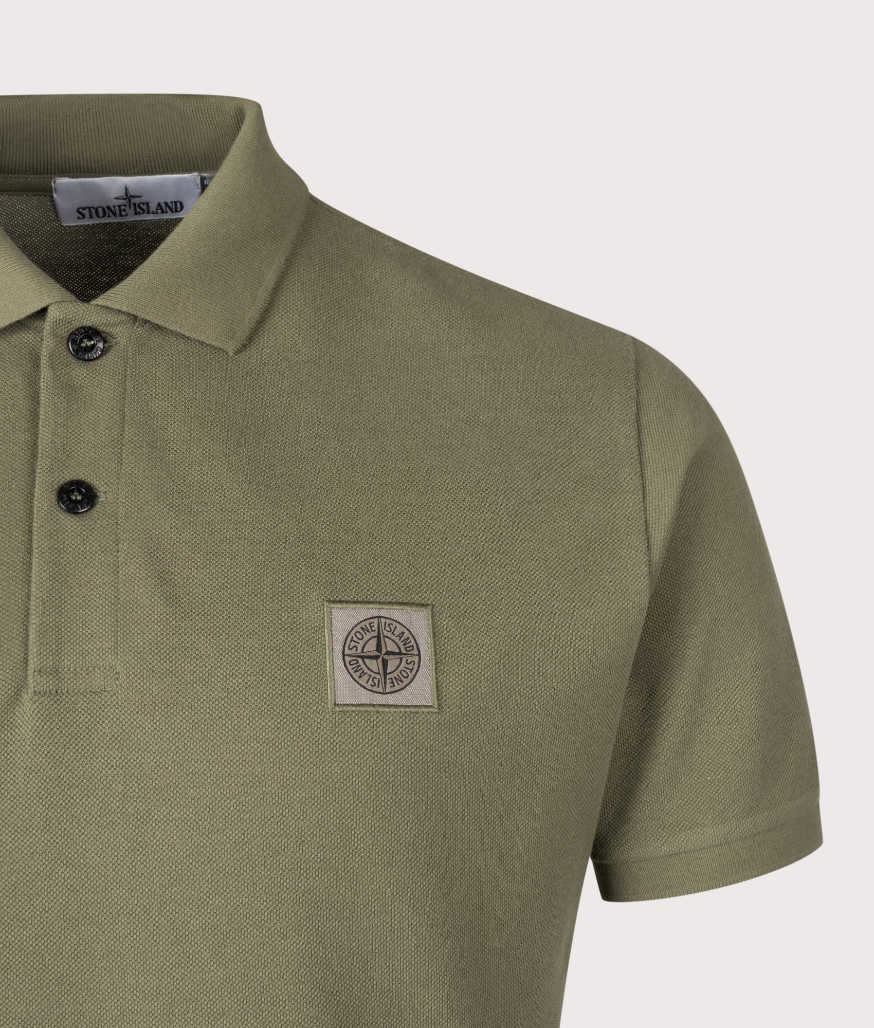 Stone Island Compass Patch Polo Shirt in Military Green at EQVVS Menswear.  Front detail shot 
