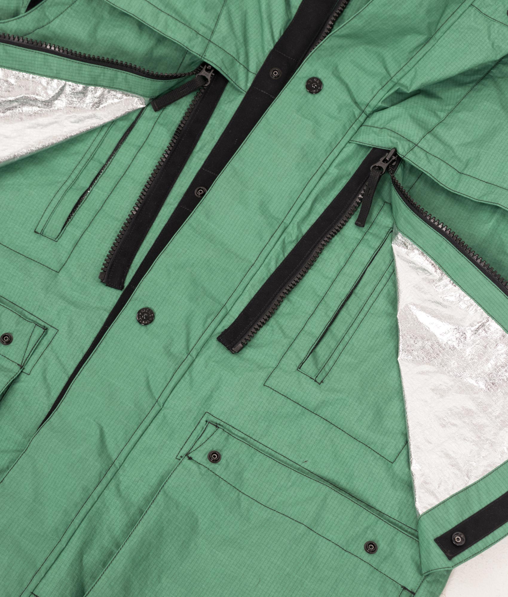 Stone Island Metal Lamina Ripstop Heat Reactive Jacket in Malachite at EQVVS Menswear. Pocket detail shot.