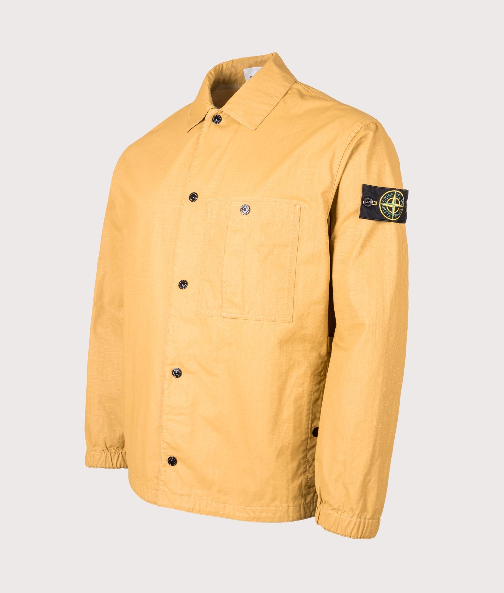 Stone Island Relaxed Fit Double Coated Cotton Ripstop Overshirt in Mustard at EQVVS Menswear. Front angle shot 