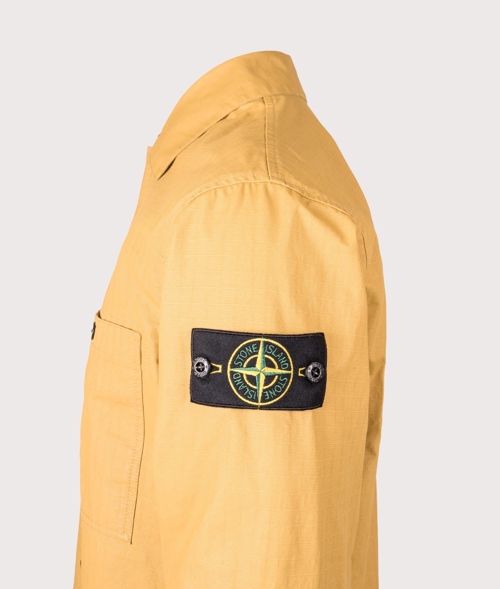 Stone Island Relaxed Fit Double Coated Cotton Ripstop Overshirt in Mustard at EQVVS Menswear.  Side detail shot 