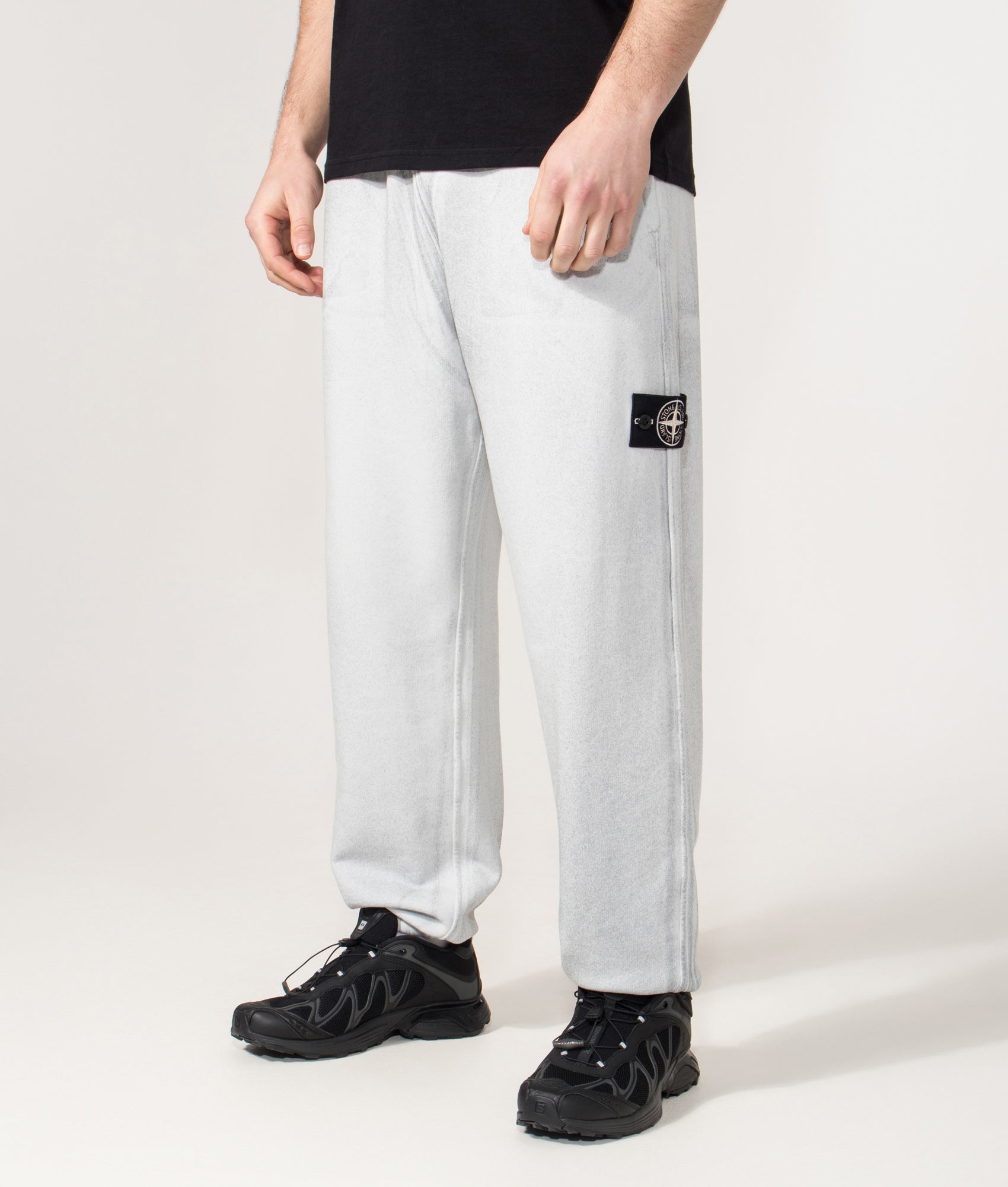 Loose Fit Reflect Joggers in Sky Blue | Stone Island | EQVVS | Front angle shot 