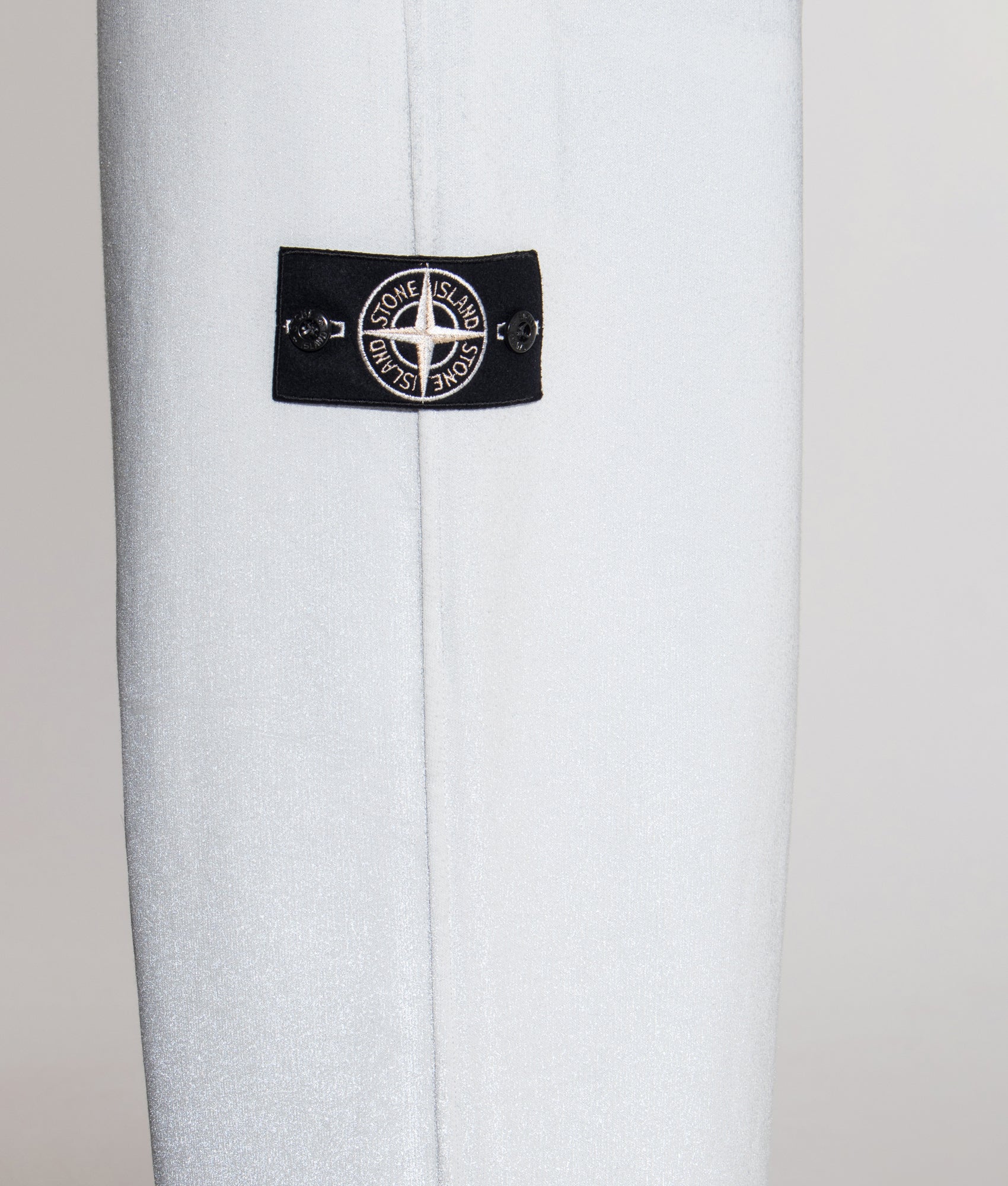 Loose Fit Reflect Joggers in Sky Blue | Stone Island | EQVVS | Side model detail shot 