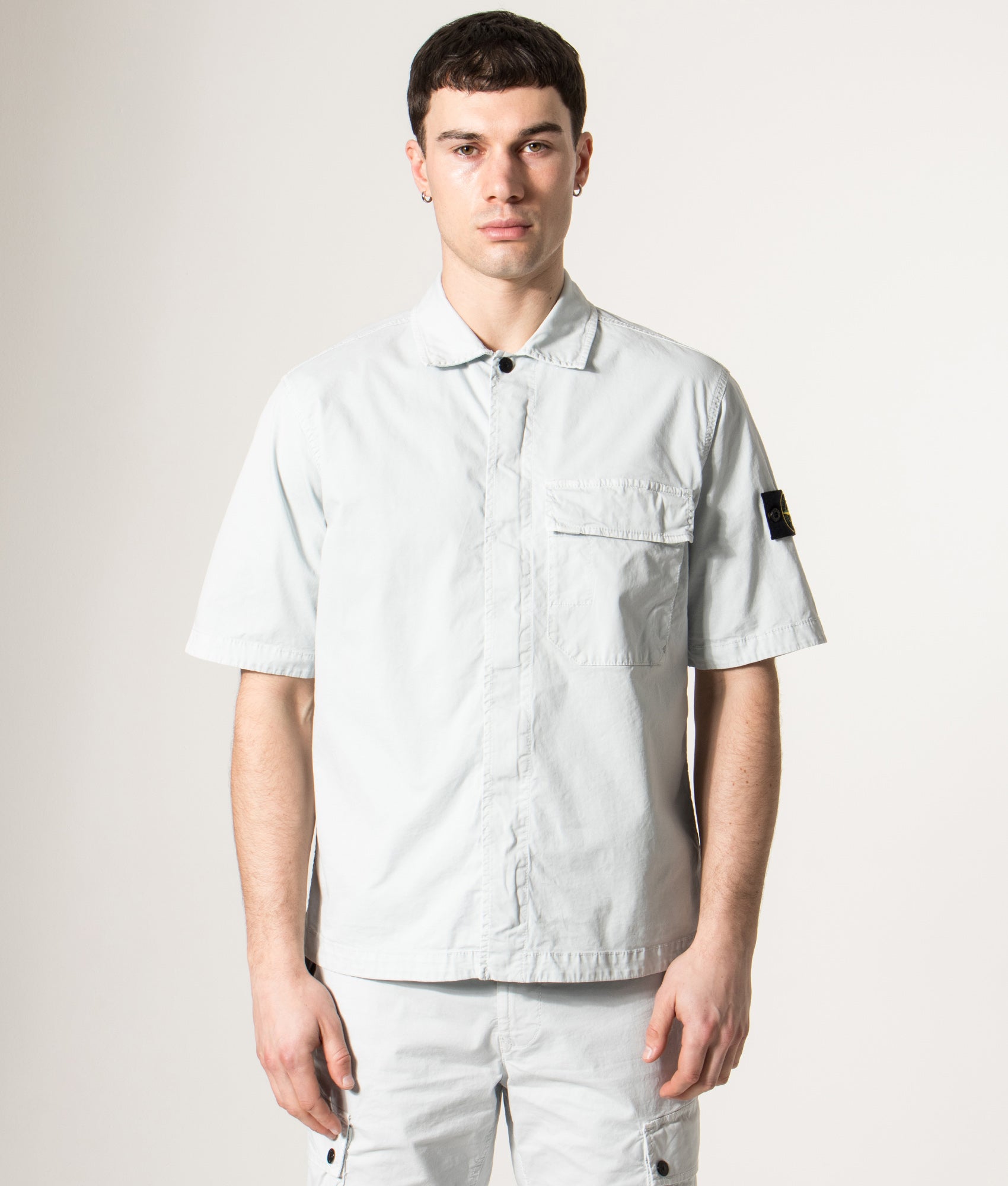 Stone Island Short Sleeve Shirt in Sky Blue at EQVVS Menswear. Model front shot.