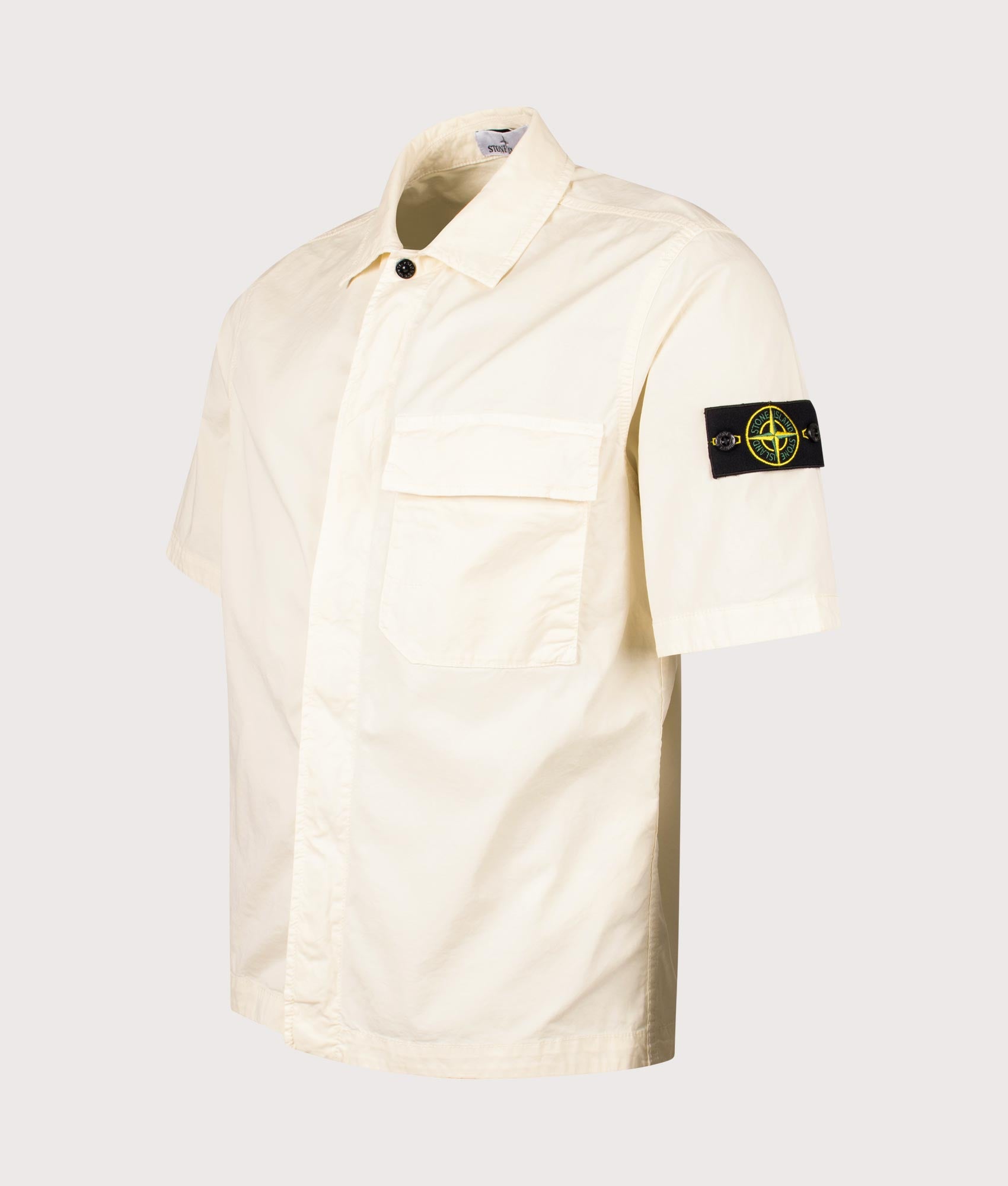 Stone Island Relaxed Fit Short Sleeve Shirt in Ivory at EQVVS Menswear. Angled front shot.