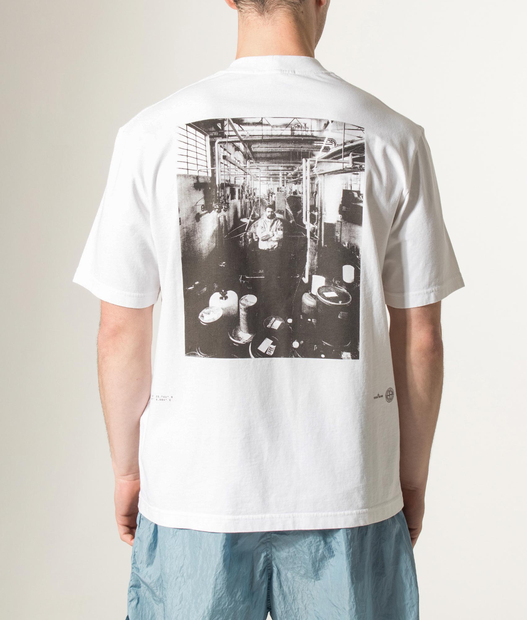 Stone island Carlo Rivetti T-Shirt in White at EQVVS Menswear. Model back shot.