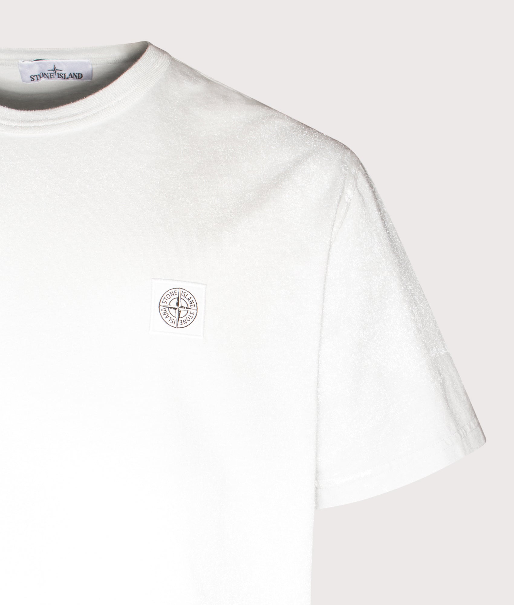 Stone Island Reflective Compass Badge T-Shirt in Sky Blue at EQVVS Menswear. Reflective detail shot.