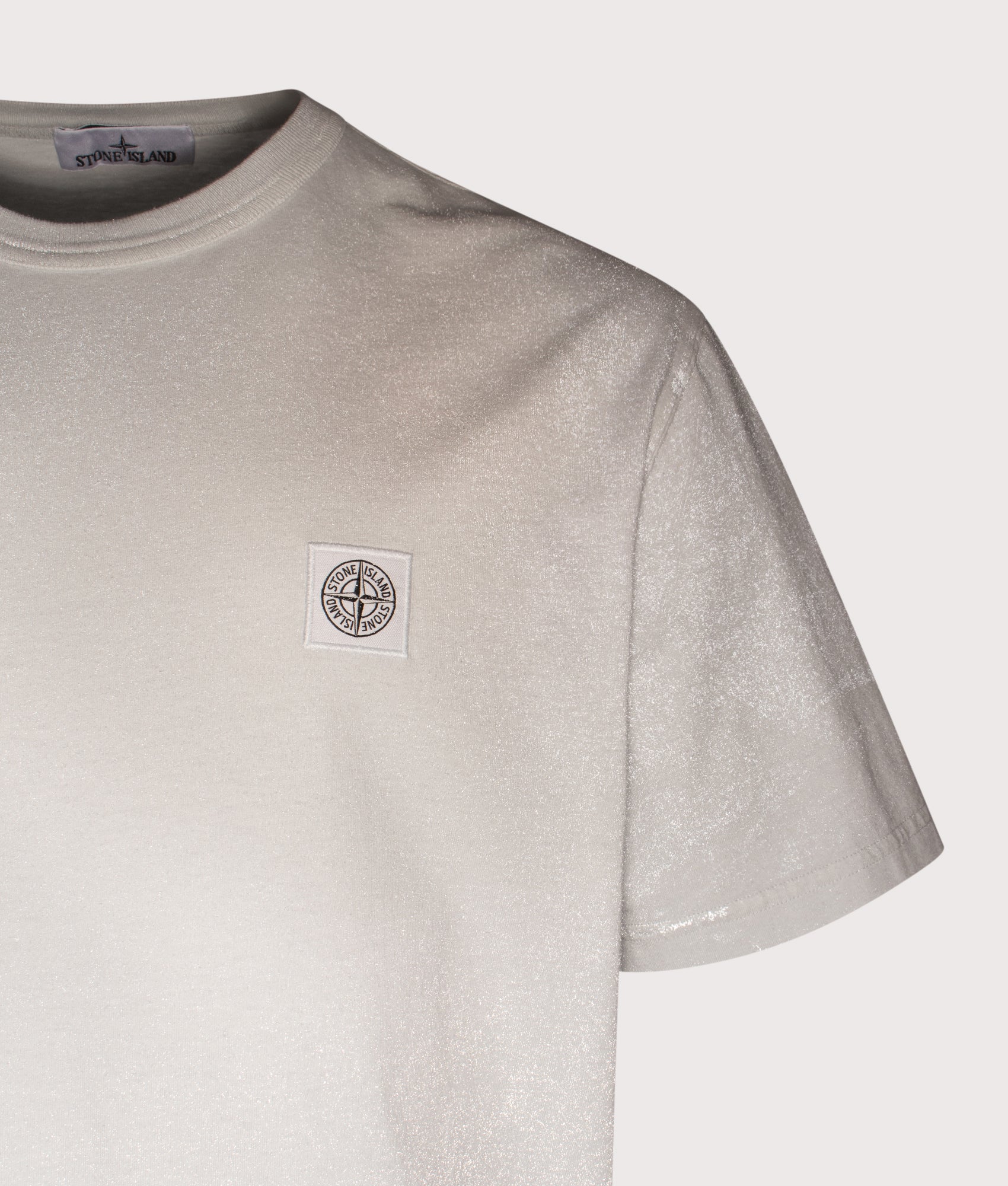 Stone Island Reflective Compass Badge T-Shirt in Sky Blue at EQVVS Menswear. Reflective detail shot.