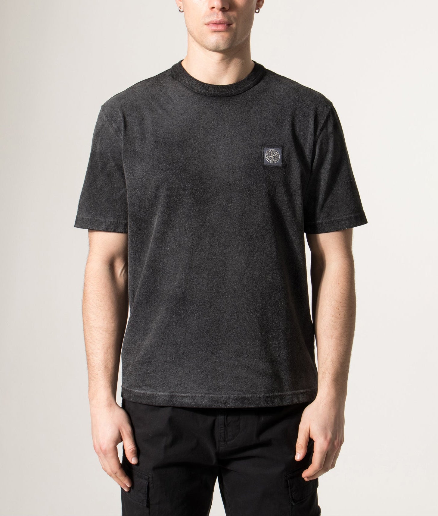 Stone Island Reflective Compass Badge Short Sleeve T-Shirt in Black at EQVVS Menswear. Model shot.