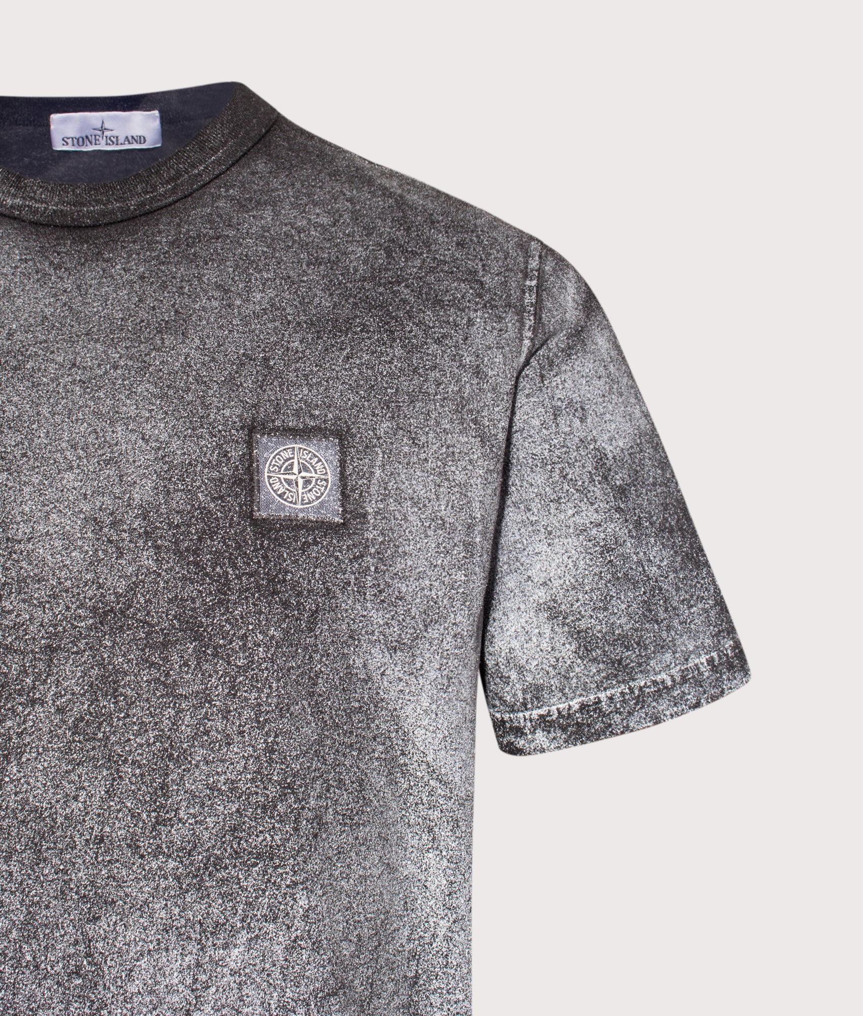 Stone Island Reflective Compass Badge Short Sleeve T-Shirt in Black at EQVVS Menswear. Reflective detail shot.