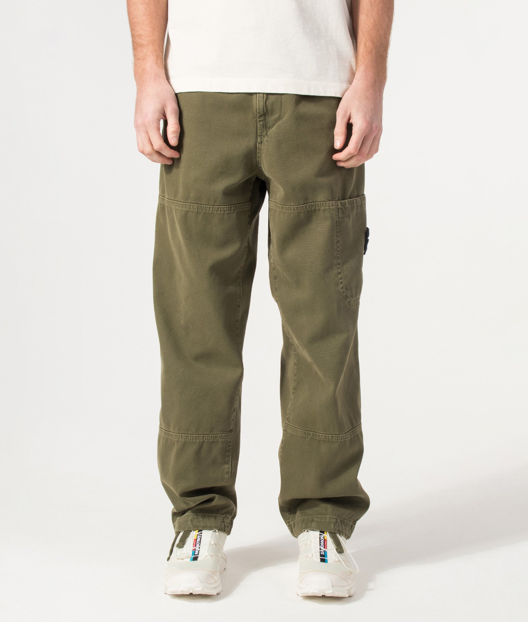 Stone Island Organic Panama Cotton 'Old' Effect Compass Pants in Military Green at EQVVS Menswear. Model front shot.