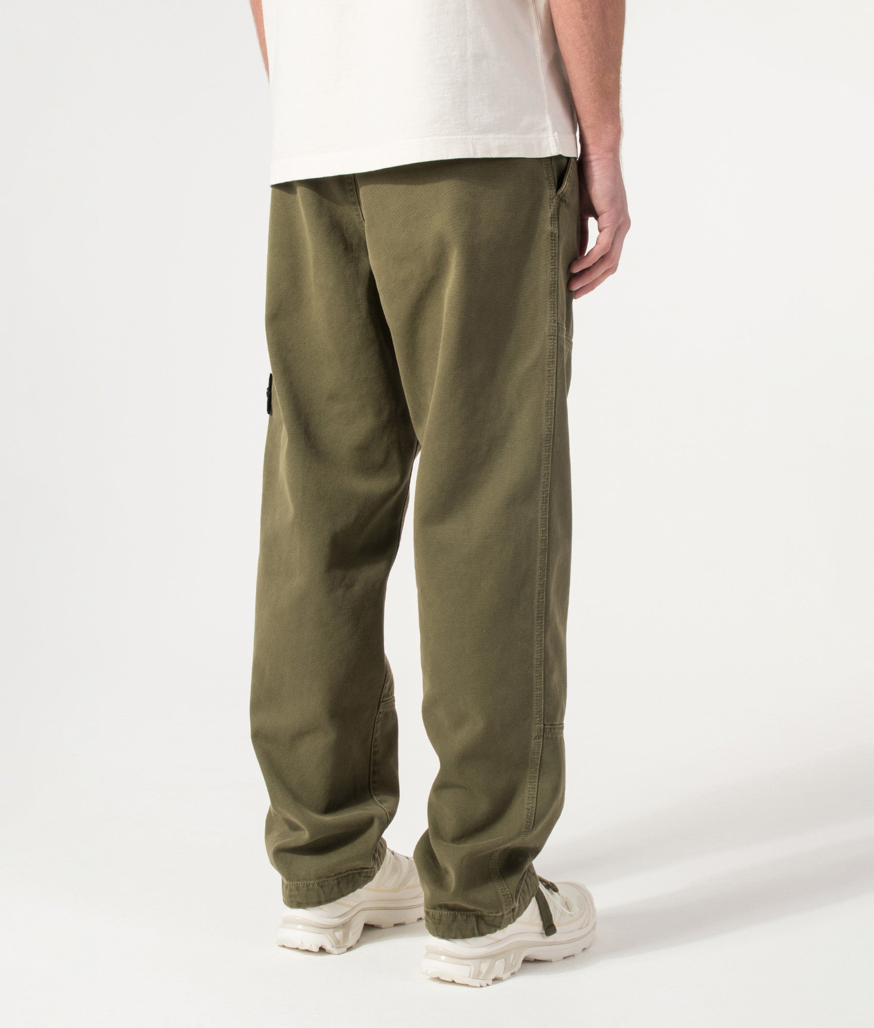 Stone Island Organic Panama Cotton 'Old' Effect Compass Pants in Military Green at EQVVS Menswear. Model back shot.