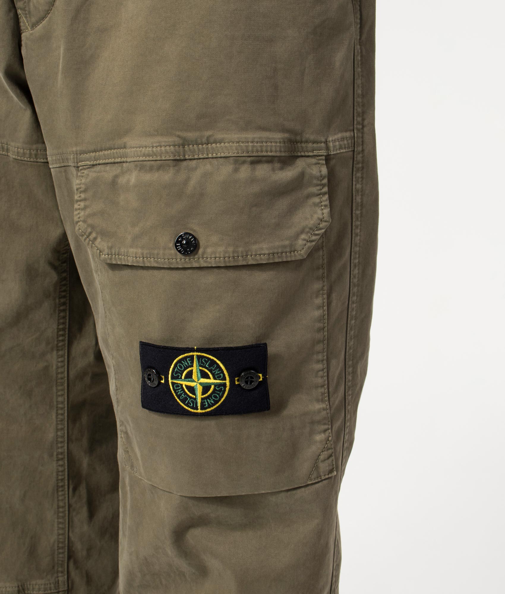Organic Twill Cargo Pants in Military Green by Stone Island. Front detail shot. Shot by EQVVS