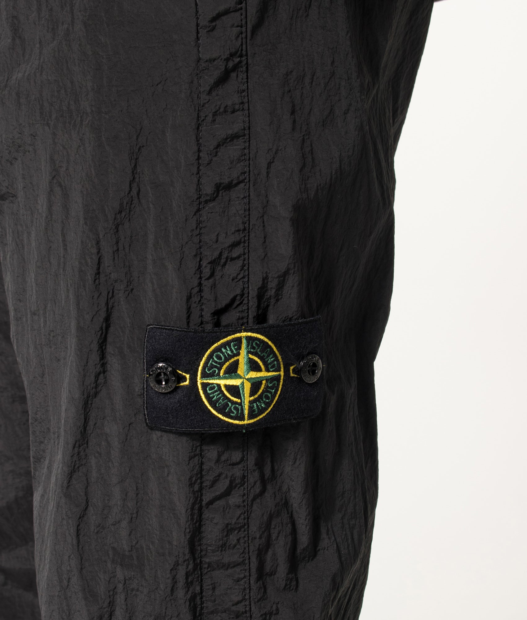Stone Island Nylon Metal in Econyl® Trousers in Black at EQVVS Menswear. Detail shot.
