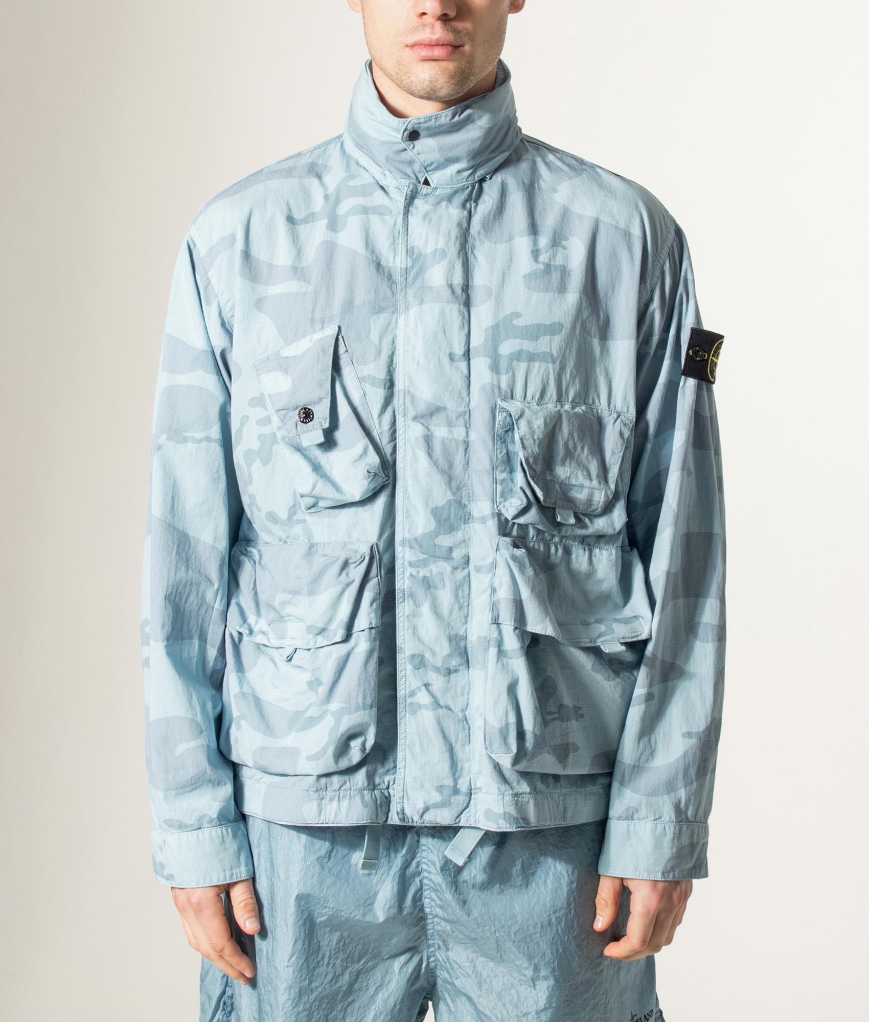 Stone Island Faded Camo Light Ripstop-OVD Field Jacket in Powder Blue at EQVVS Menswear. Model front shot.