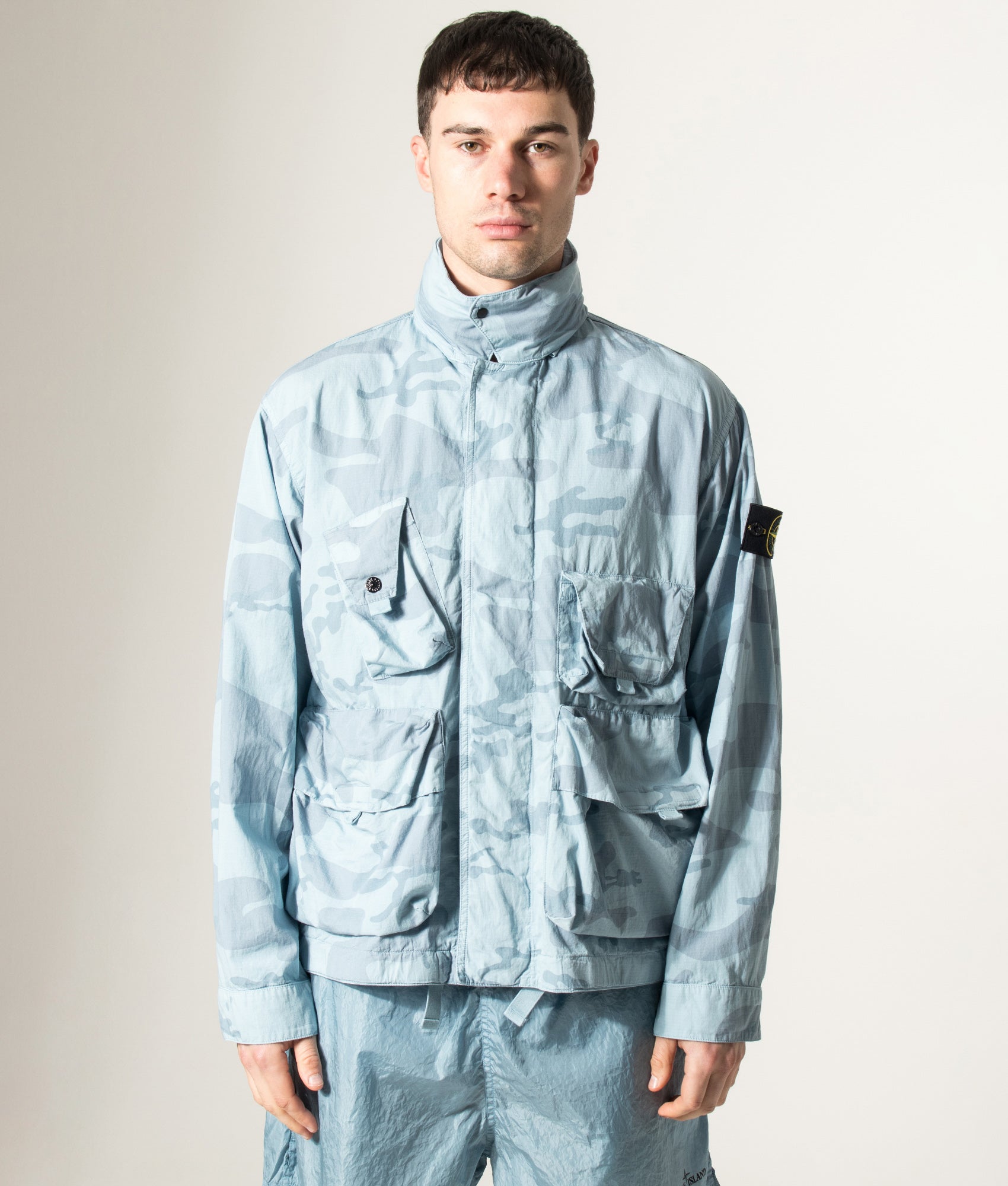 Stone Island Faded Camo Light Ripstop-OVD Field Jacket in Powder Blue at EQVVS Menswear. Model front shot.