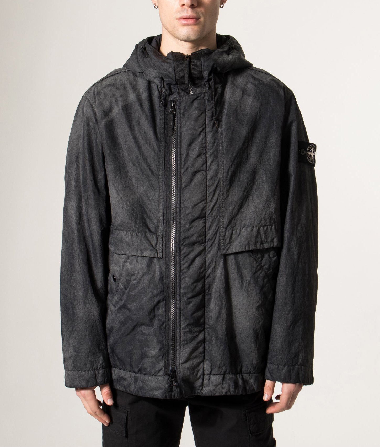 Stone Island Dense Nylon-TC Hand Sprayed Reflective Jacket in Black at EQVVS Menswear. Model front shot.
