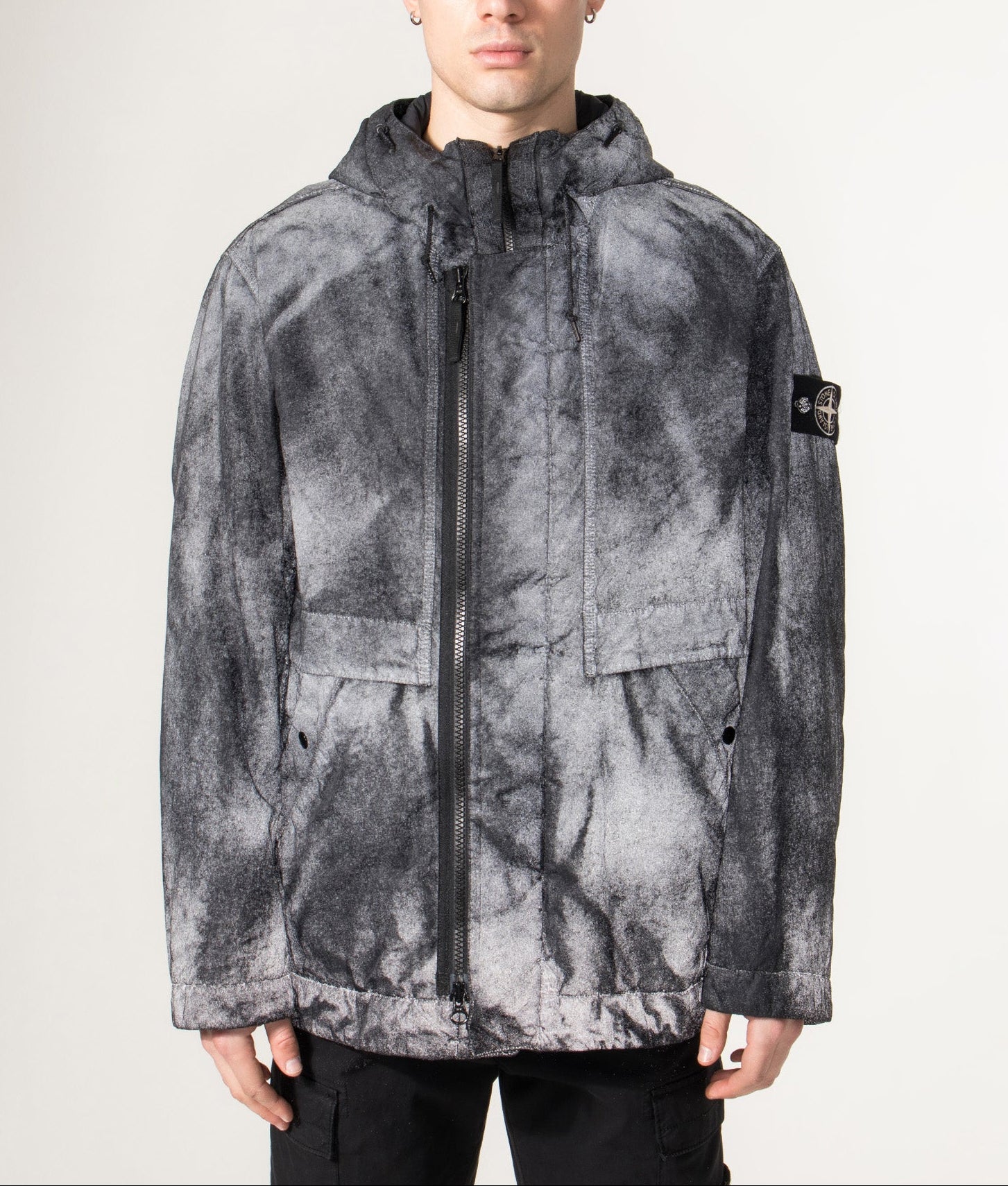 Stone Island Dense Nylon-TC Hand Sprayed Reflective Jacket in Black at EQVVS Menswear. Reflective model shot.