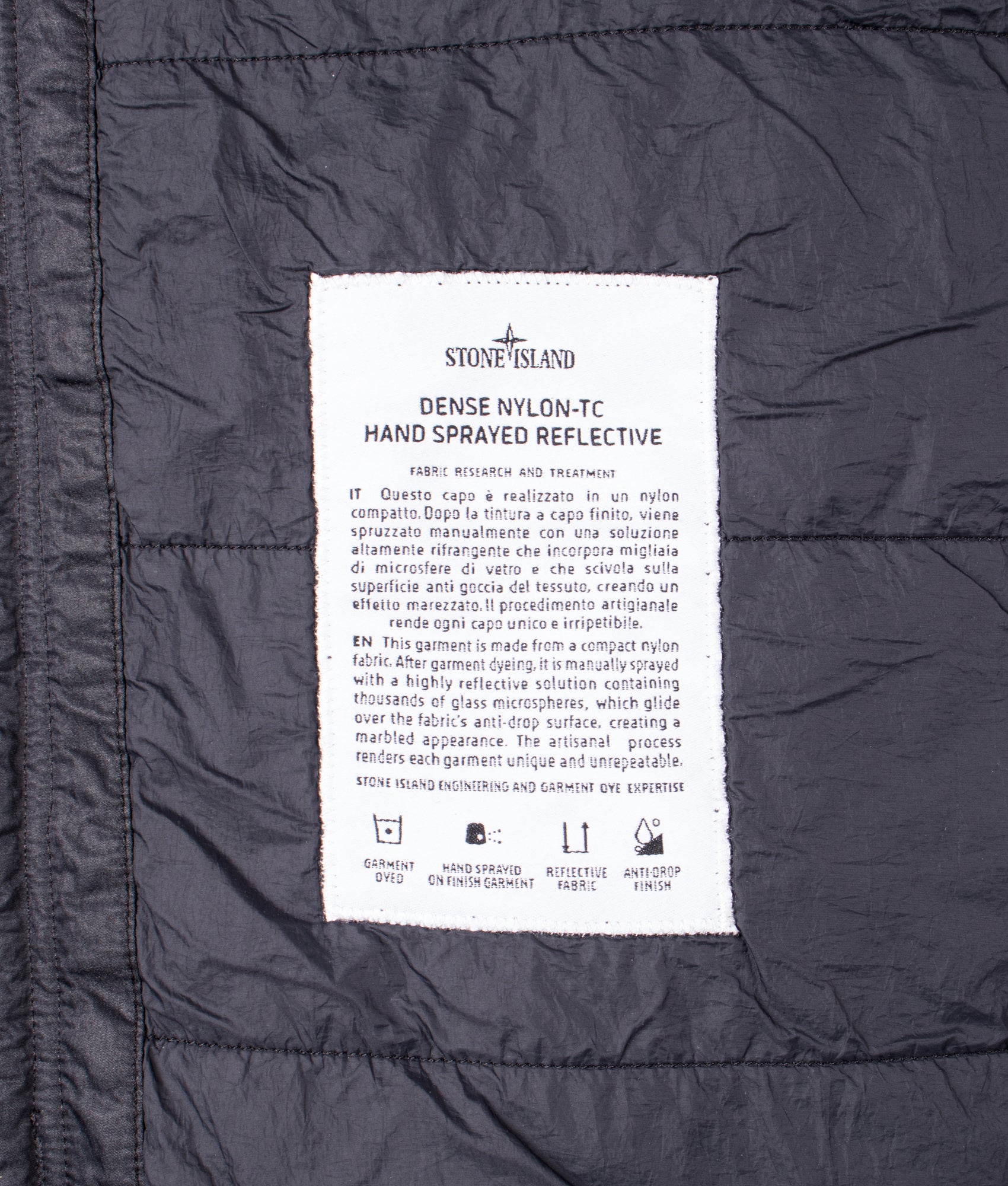 Stone Island Dense Nylon-TC Hand Sprayed Reflective Jacket in Black at EQVVS Menswear. Label shot.