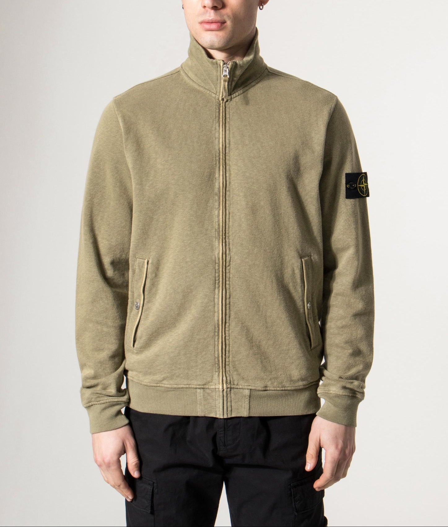 Stone Island Malfilé ‘Old’ Treatment Zip Up Track Jacket in Military green at EQVVS Menswear. Model shot.