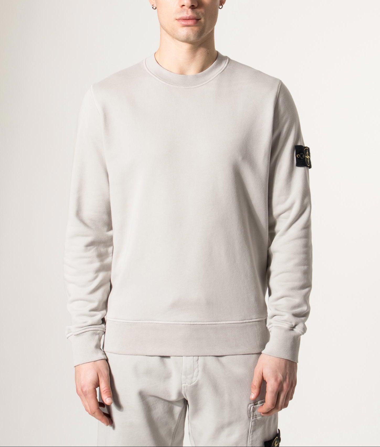 Stone Island Organic Cotton Sweatshirt in Pearl Grey at EQVVS Menswear. Model front shot.