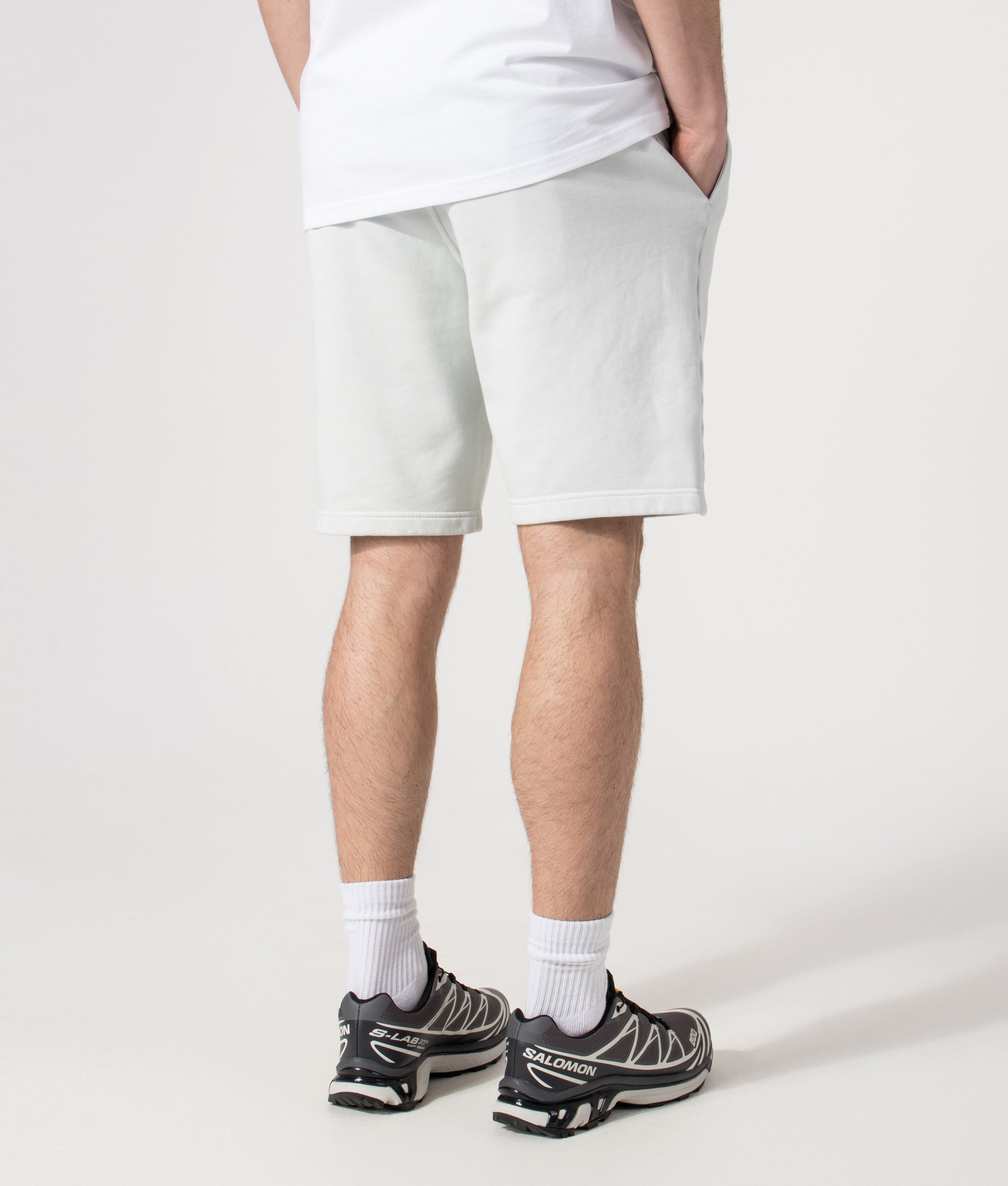 Stone Island Sweat Shorts in Sky Blue at EQVVS Menswear. Angled model back shot.