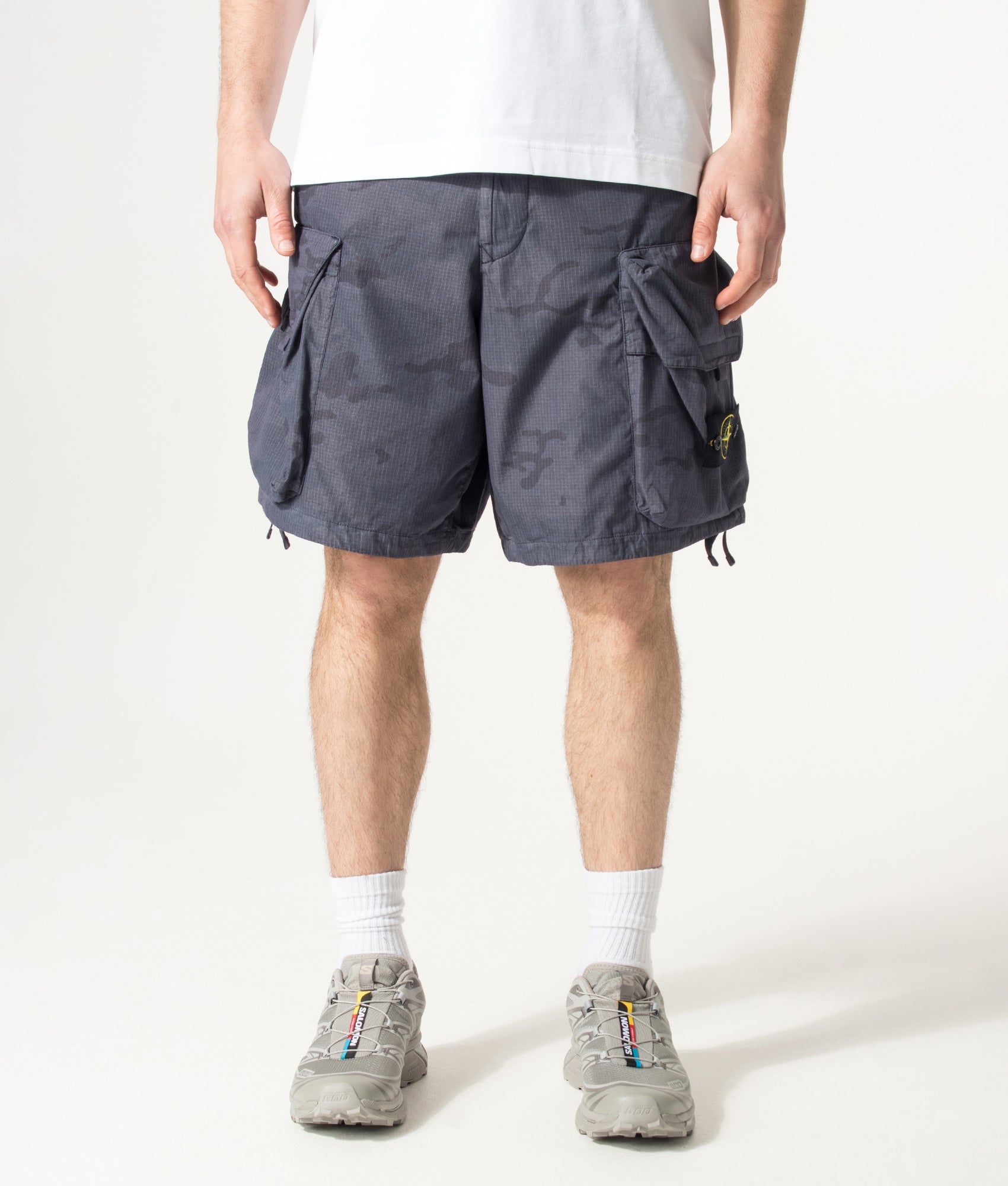 Stone Island Cotton Nylon Micro Ripstop Cargo Shorts in Blue Grey at EQVVS Menswear. Model front shot.