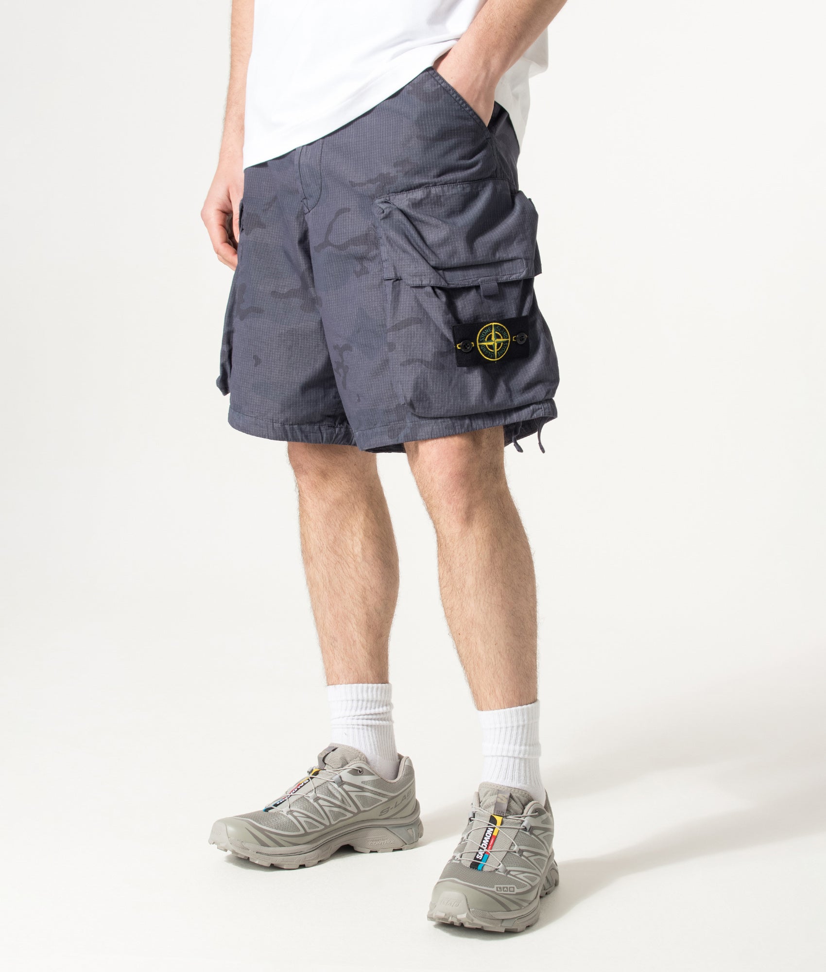 Stone Island Cotton Nylon Micro Ripstop Cargo Shorts in Blue Grey at EQVVS Menswear. Angled model front shot.