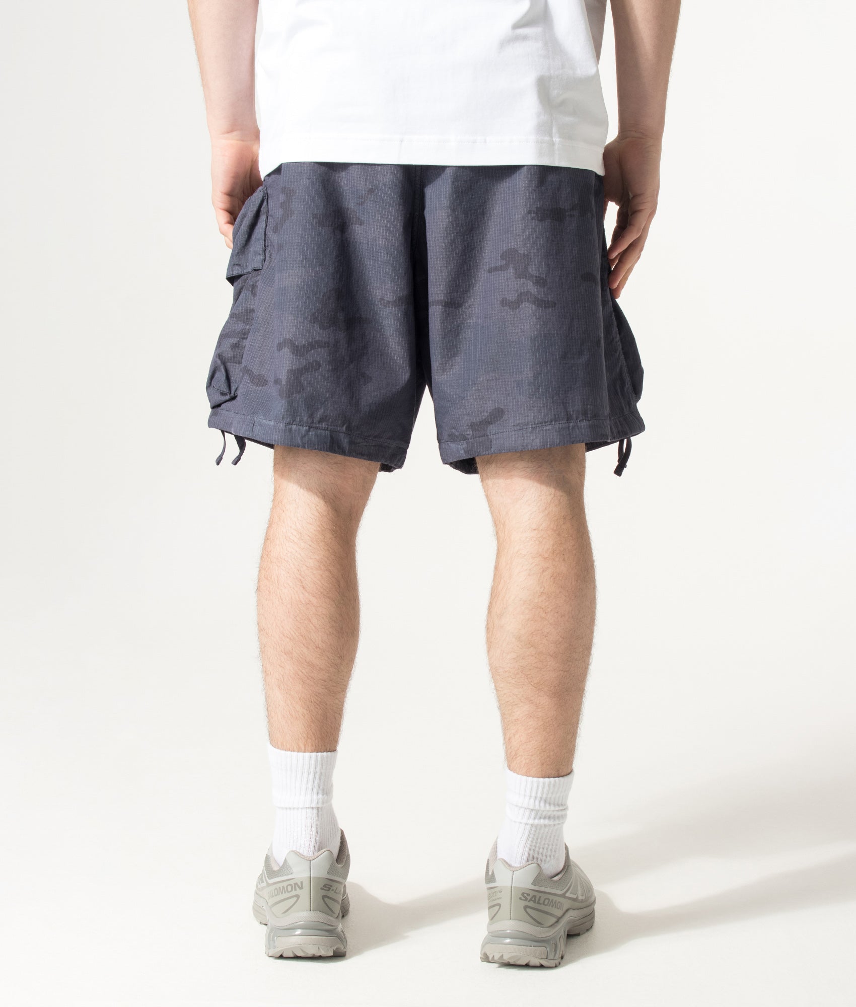Stone Island Cotton Nylon Micro Ripstop Cargo Shorts in Blue Grey at EQVVS Menswear. Model back shot.