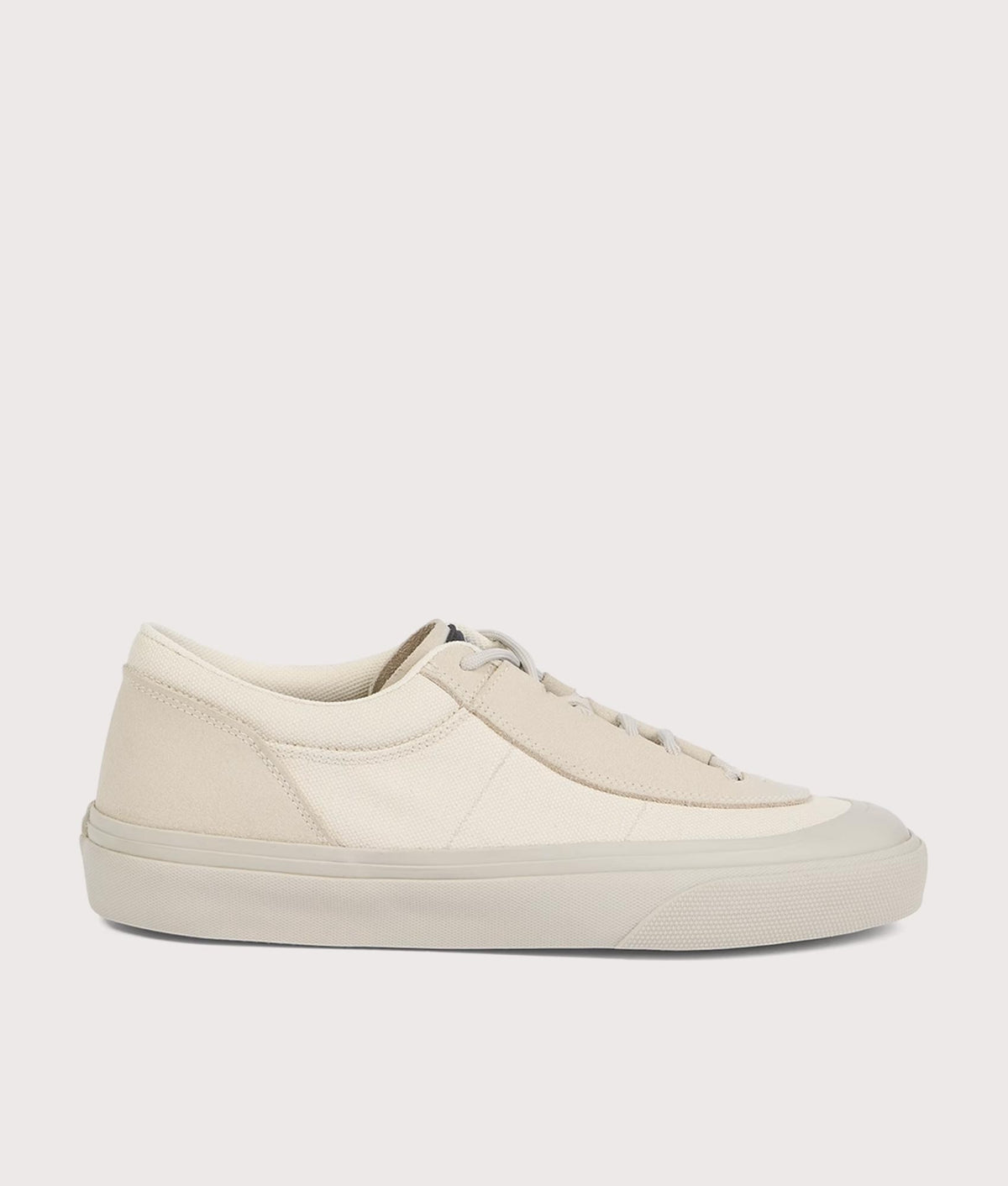 Stone Island Canvas Suede Low Top Trainers in Ivory at EQVVS Menswear. Side shot.