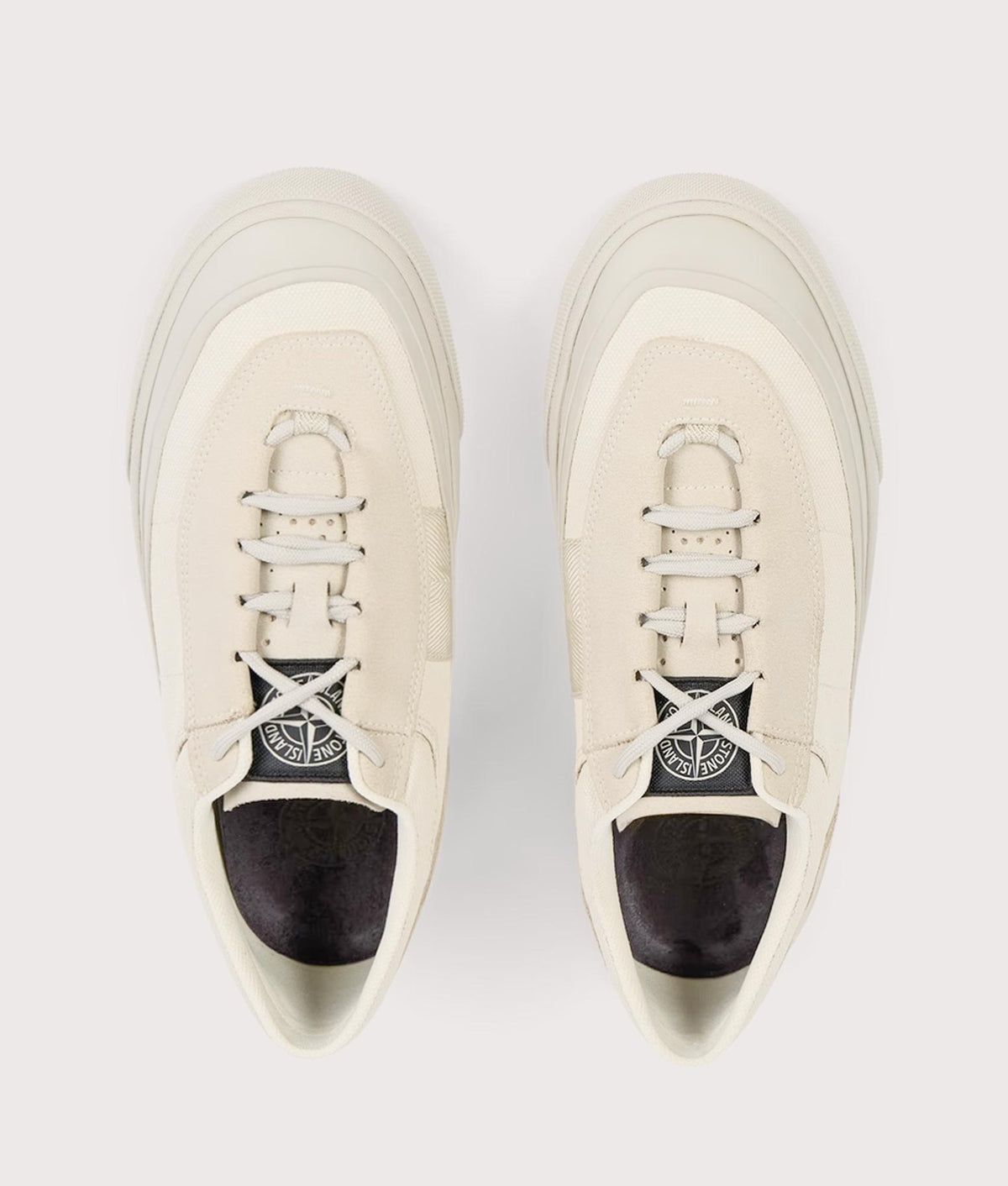 Stone Island Canvas Suede Low Top Trainers in Ivory at EQVVS Menswear. Top shot.