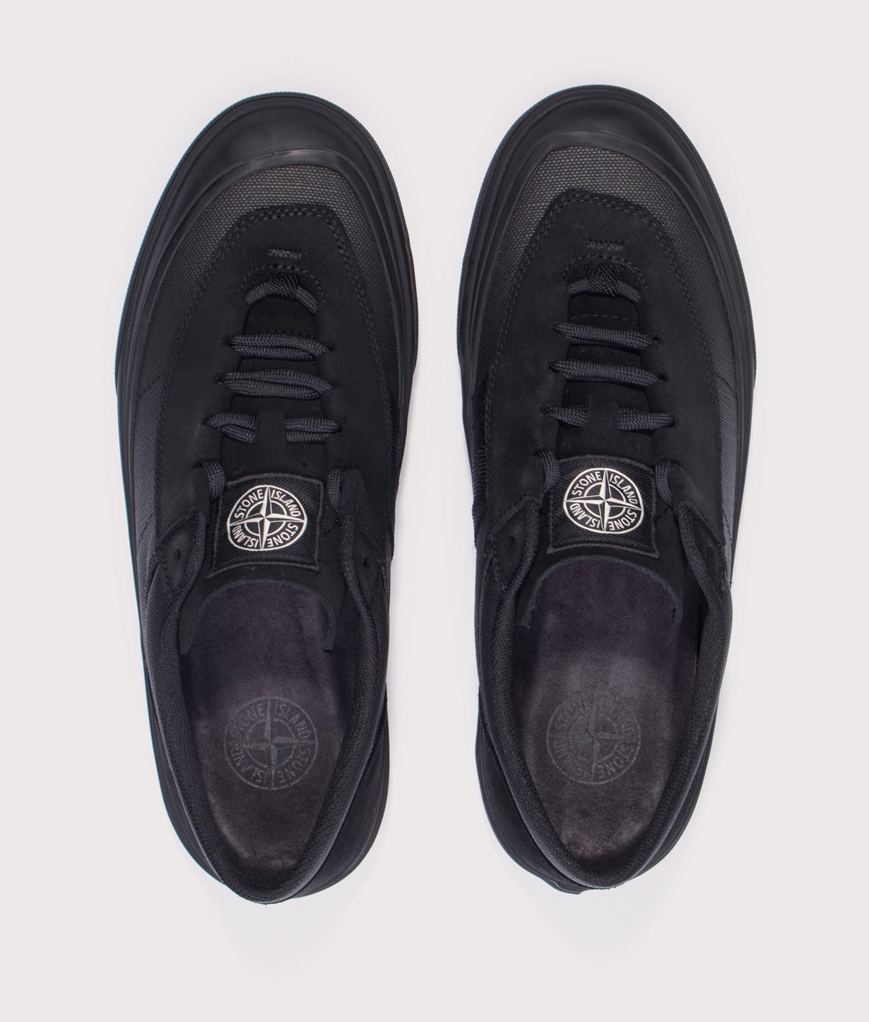 Stone Island Canvas Suede Low Top Trainers in Black at EQVVS Menswear. Top shot.
