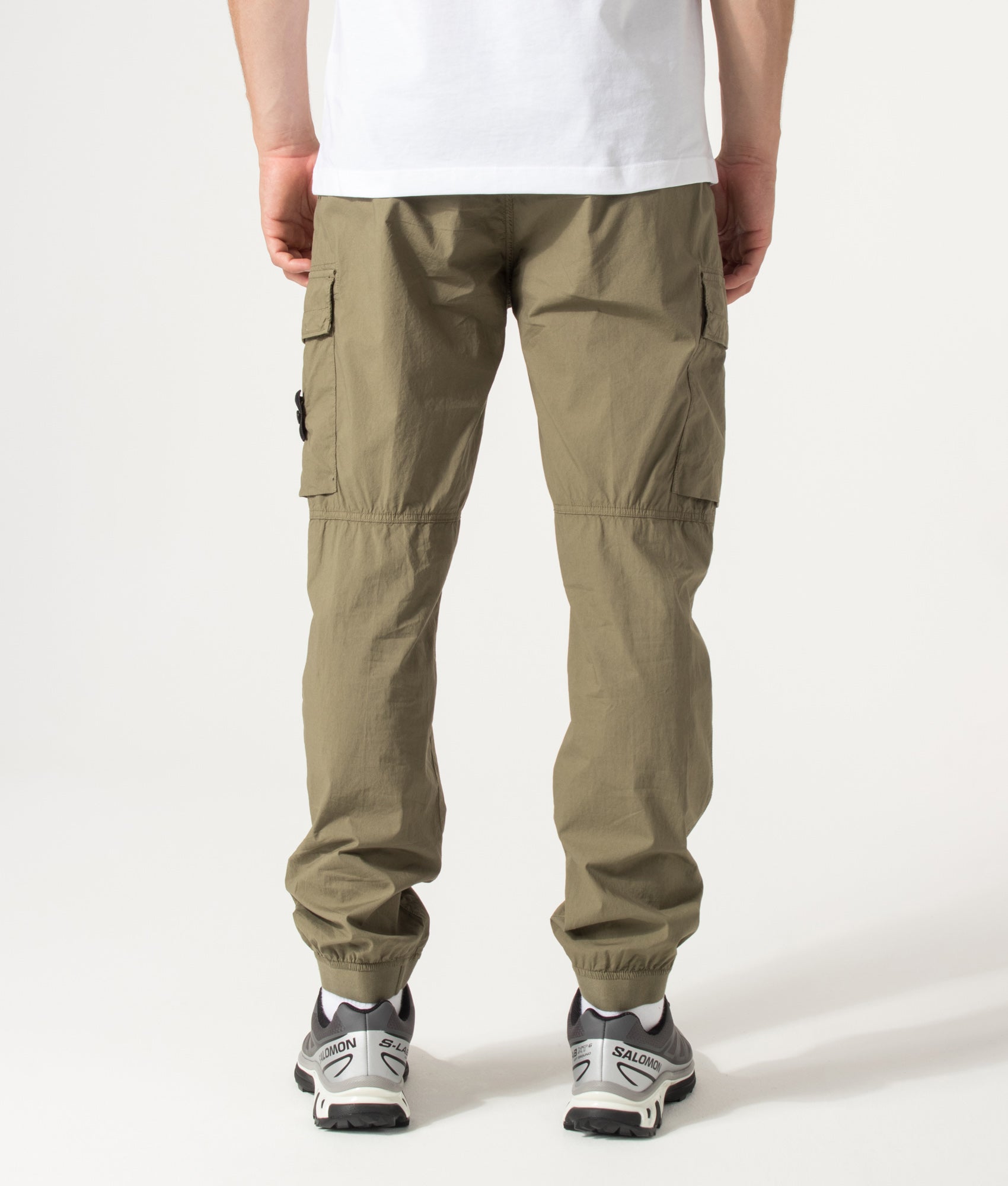 Stone Island Regular Tapered Fit Cargo Pants in Military Green at EQVVS Menswear. Model back shot.