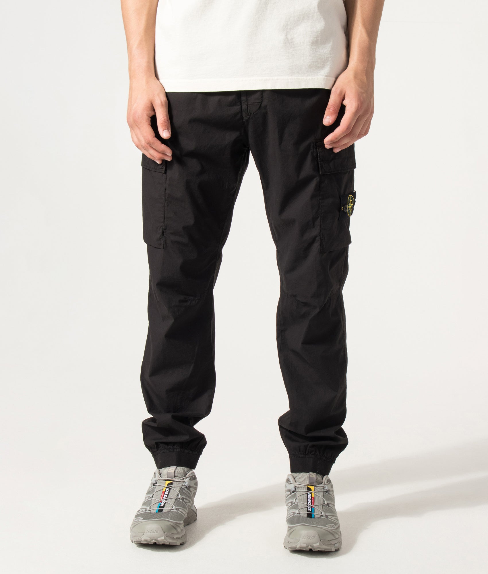 Stone Island Regular Tapered Fit Cargo Pants in Black at EQVVS Menswear. Model front shot.