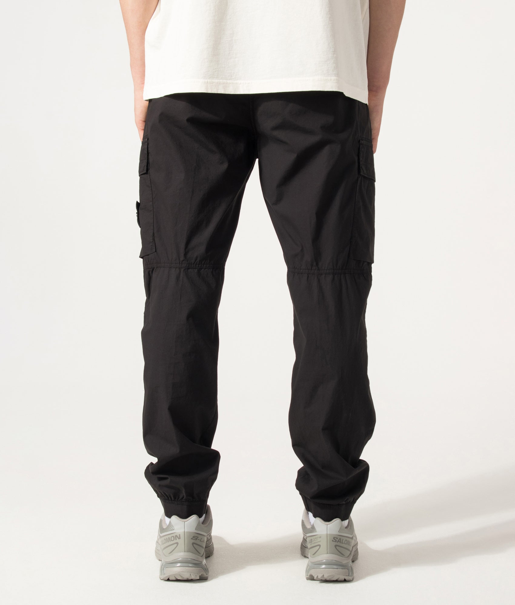 Stone Island Regular Tapered Fit Cargo Pants in Black at EQVVS Menswear. Model back shot.