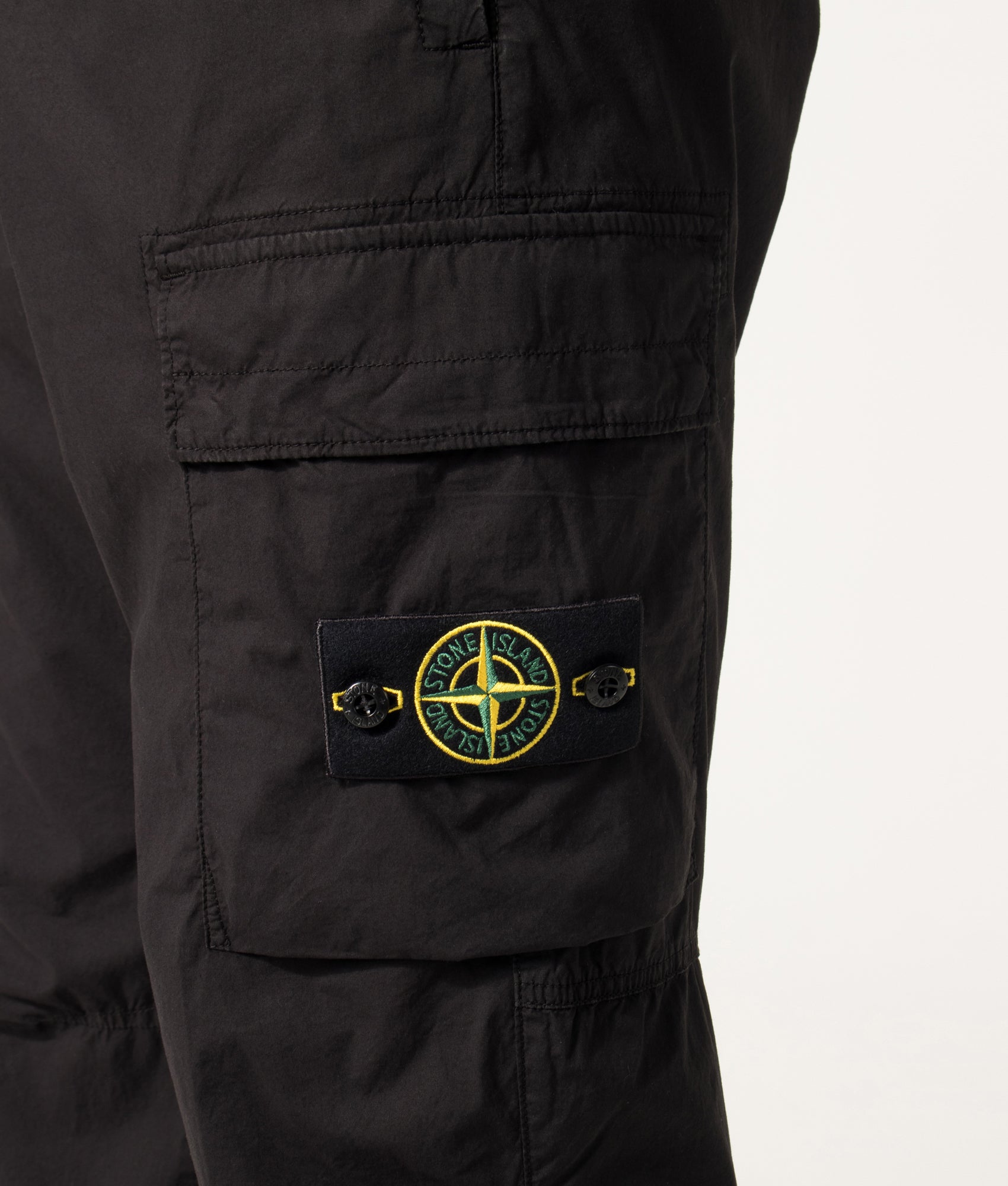 Stone Island Regular Tapered Fit Cargo Pants in Black at EQVVS Menswear. Detail shot.