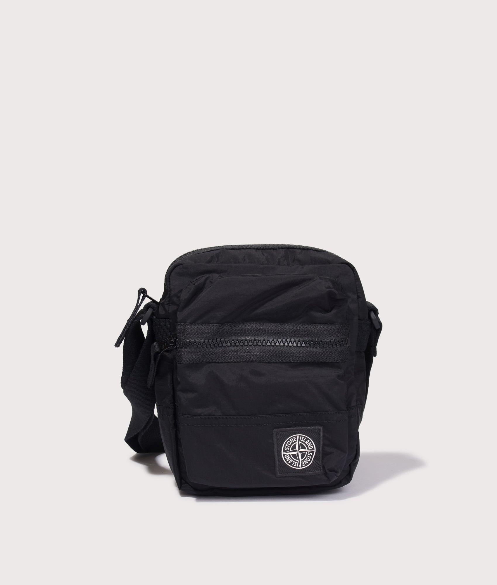 Stone Island Coated Nylon Metal in Econyl® Crossbody Bag in Black at EQVVS Menswear. Front shot.