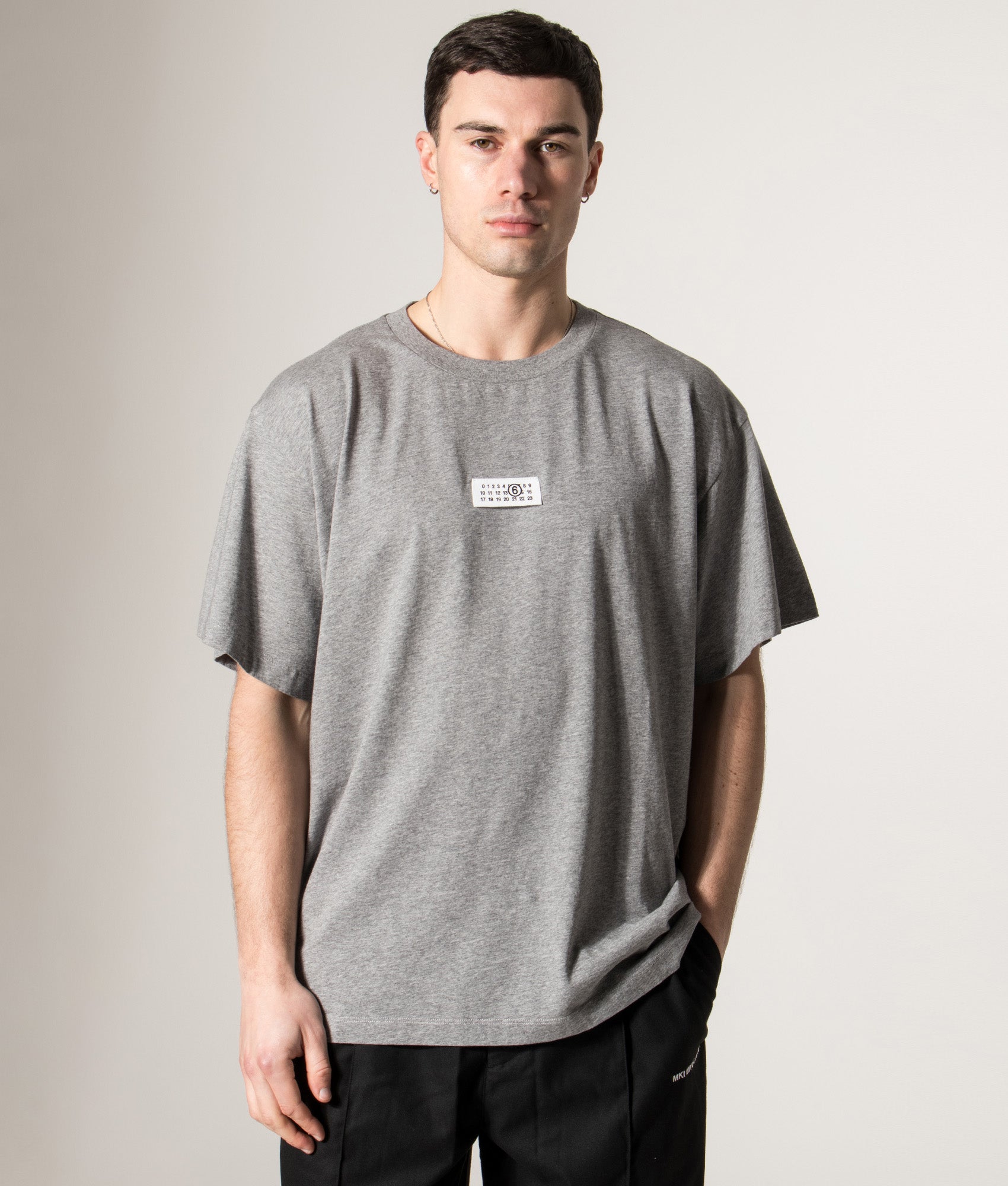 MM6 Maison Margiela Numeric Cotton T-Shirt in Light Grey Melange at EQVVS Menswear. Model front shot.