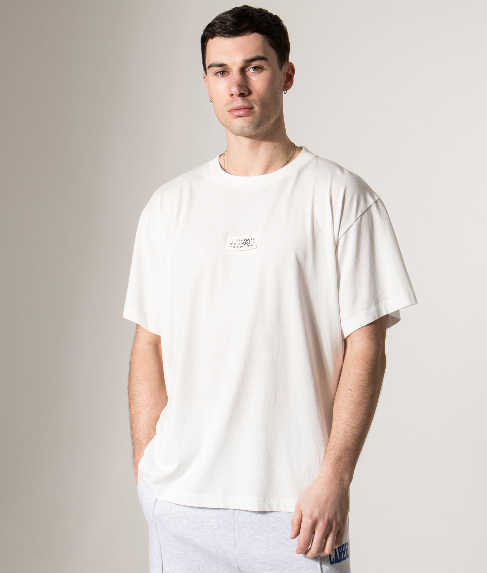 MM6 Maison Margiela Numeric Cotton T-Shirt in Off White at EQVVS Menswear. Model front shot.