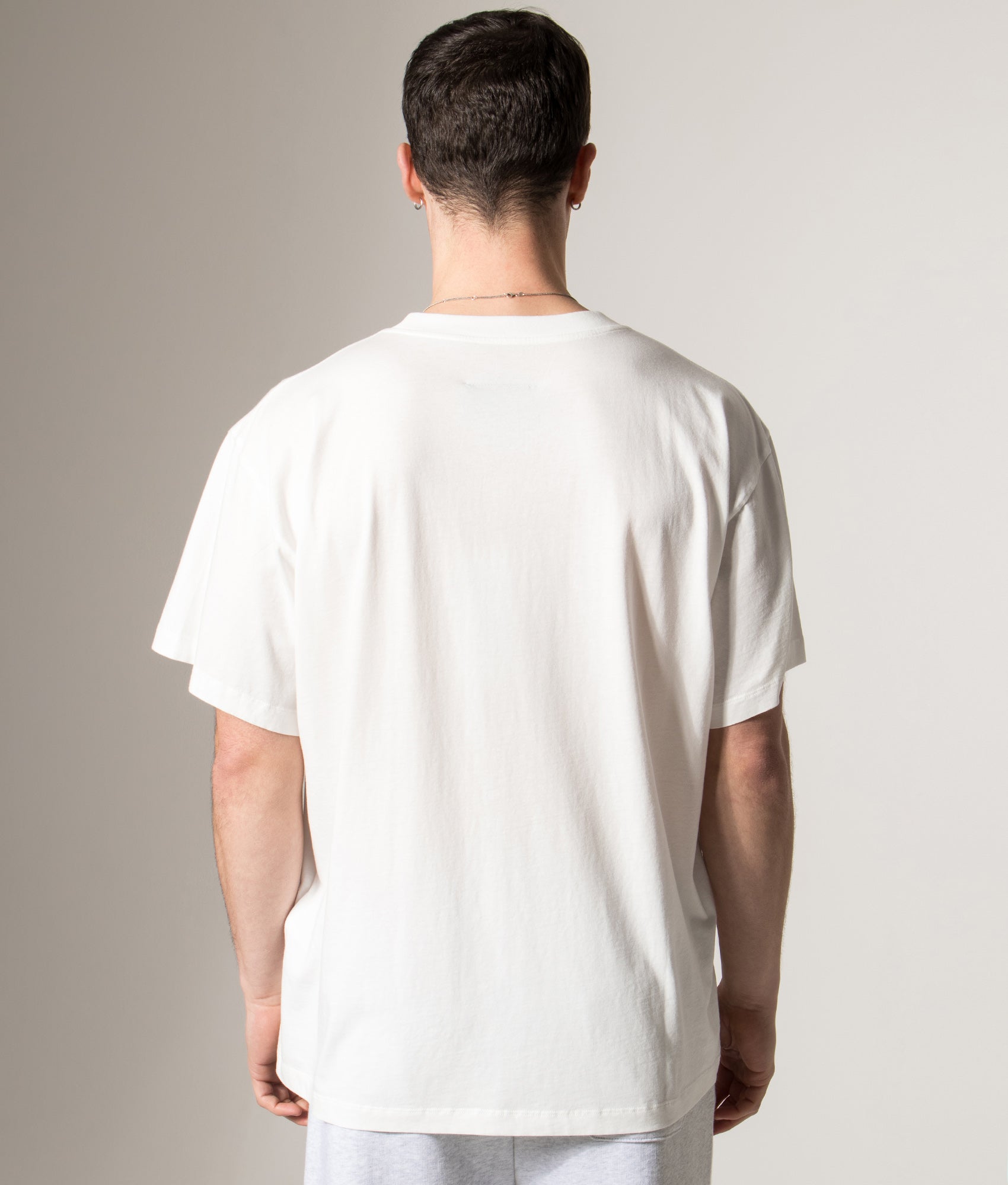 MM6 Maison Margiela Numeric Cotton T-Shirt in Off White at EQVVS Menswear. Model back shot.
